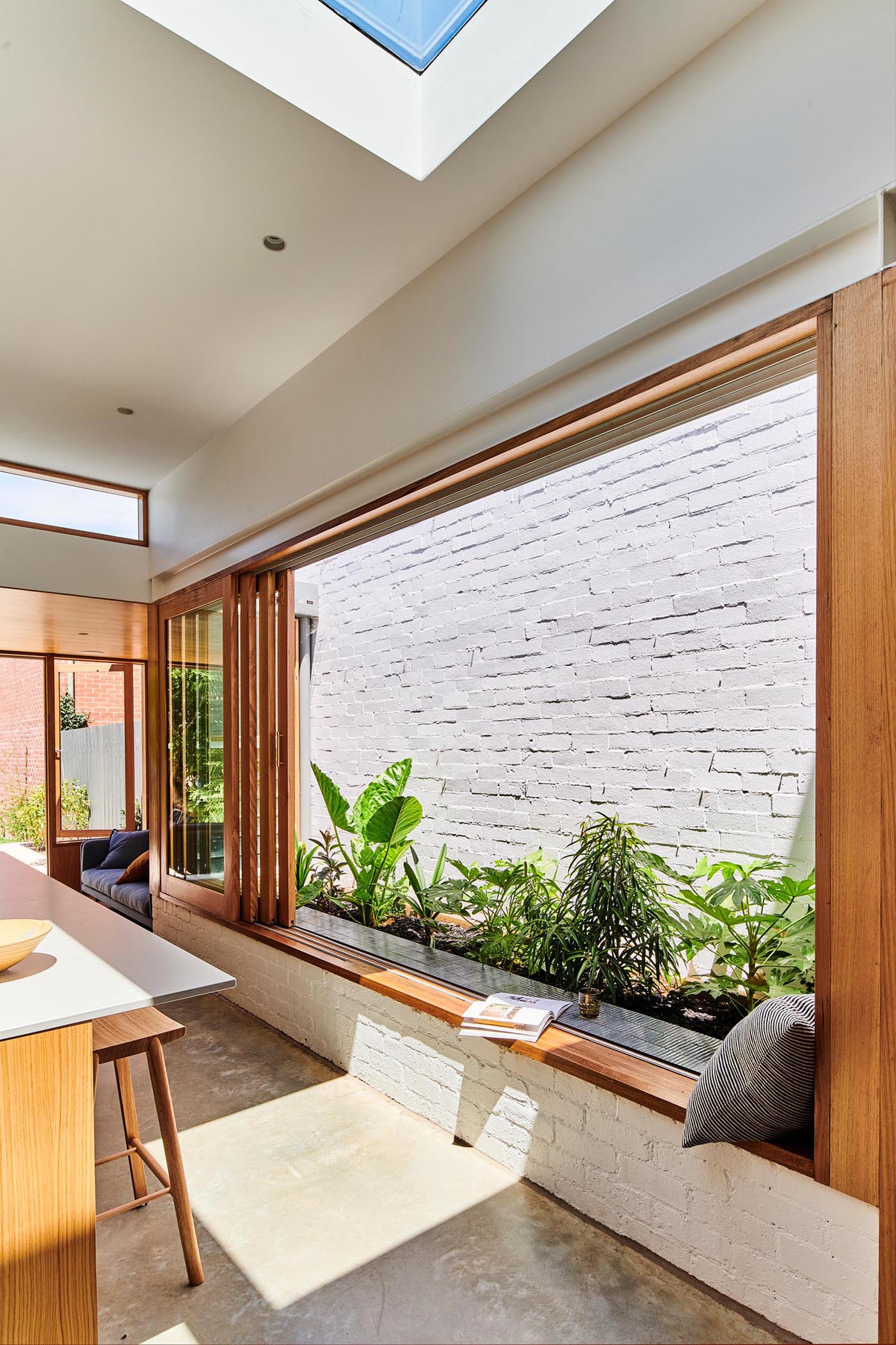 A window frame that doubles as a window seat, allowing the kitchen to become a gathering space for both family and friends.