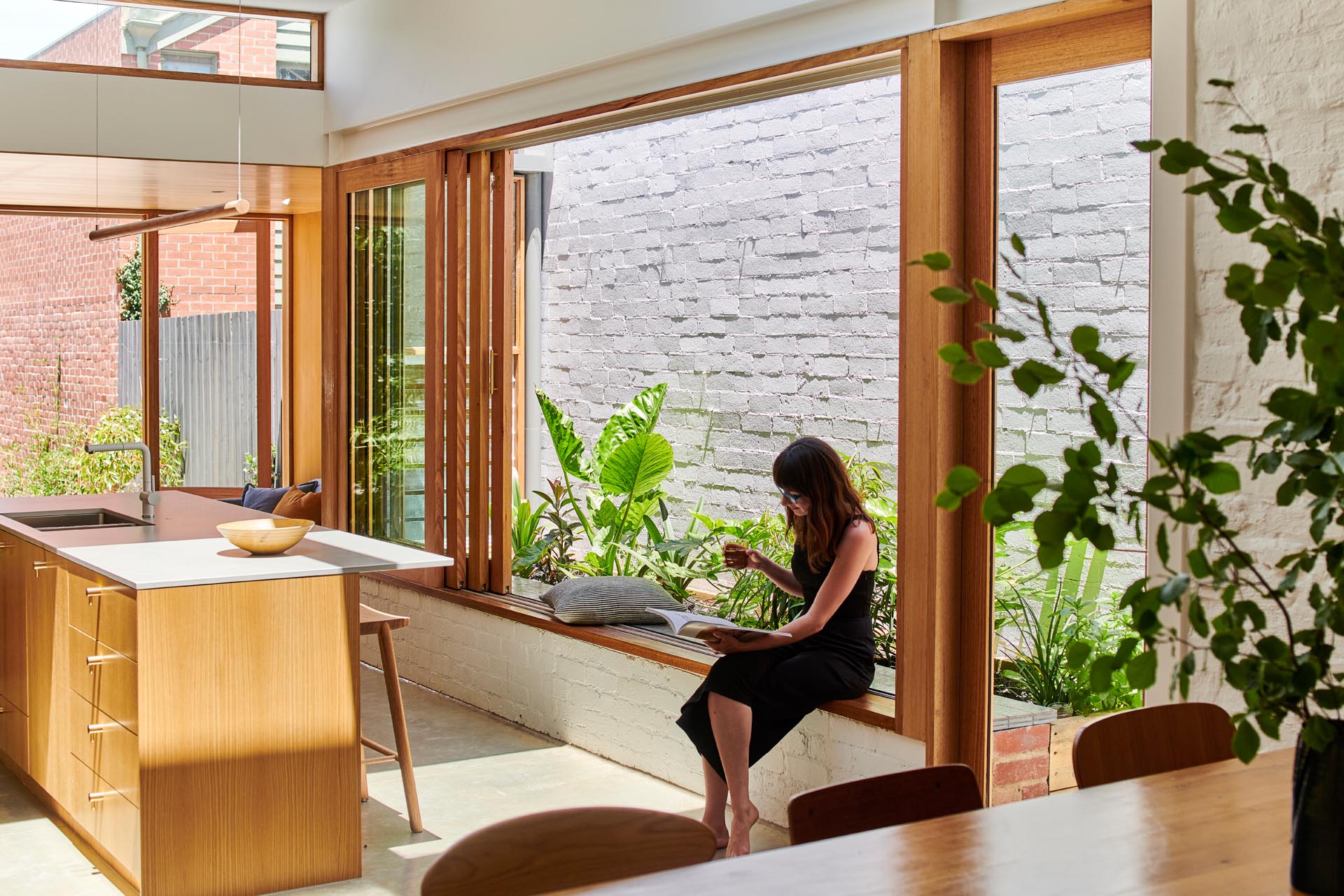 A window frame that doubles as a window seat, allowing the kitchen to become a gathering space for both family and friends.