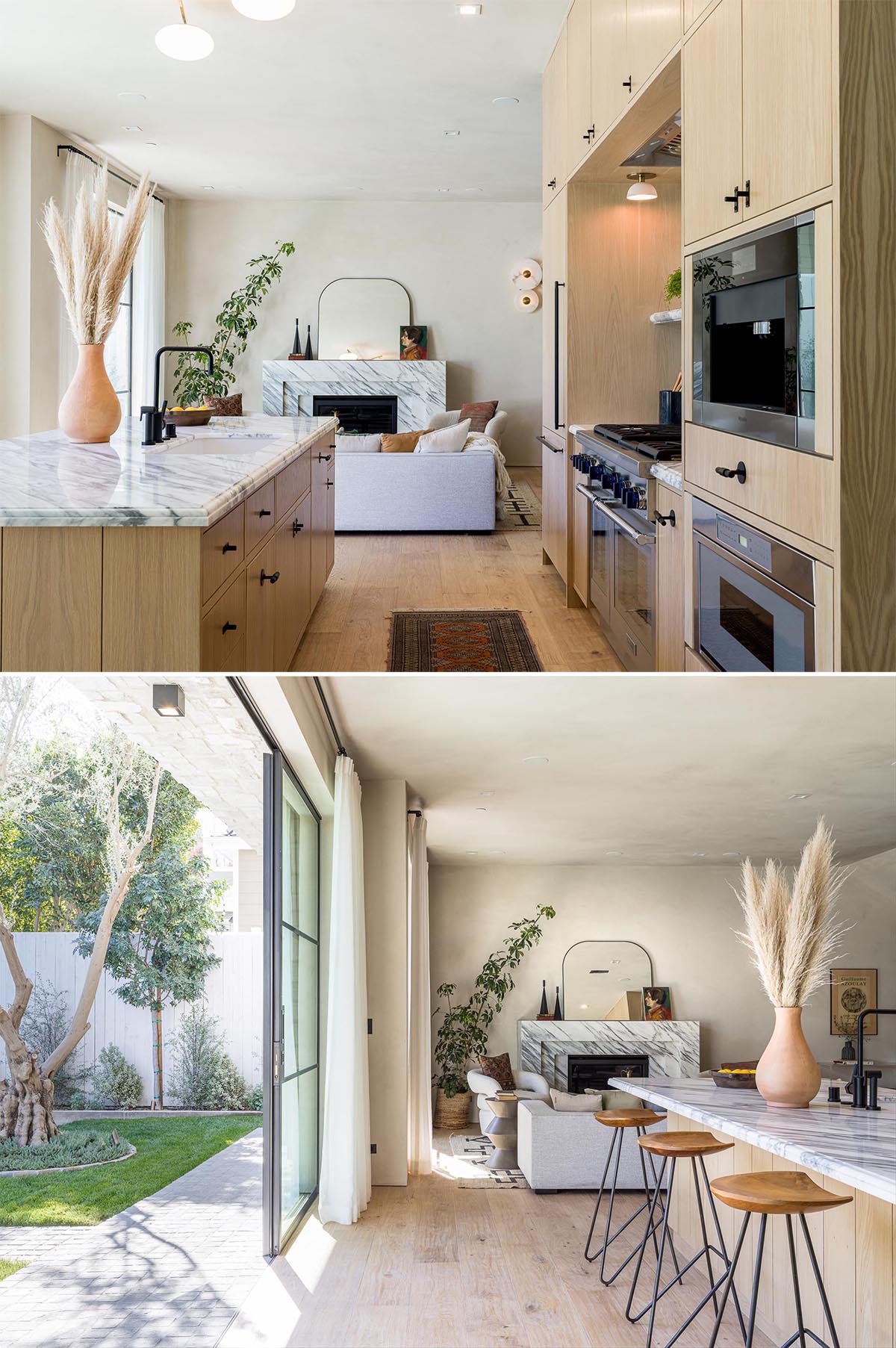 This modern kitchen includes stainless steel appliances, floor-to-ceiling white oak cabinetry, black hardware, and marble countertops.