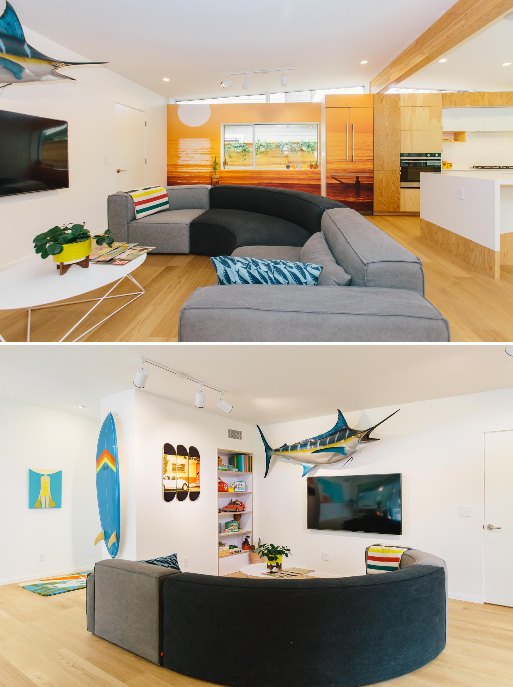 This updated living room is defined by a curved couch, built-in shelving, and a beach-inspired mural.