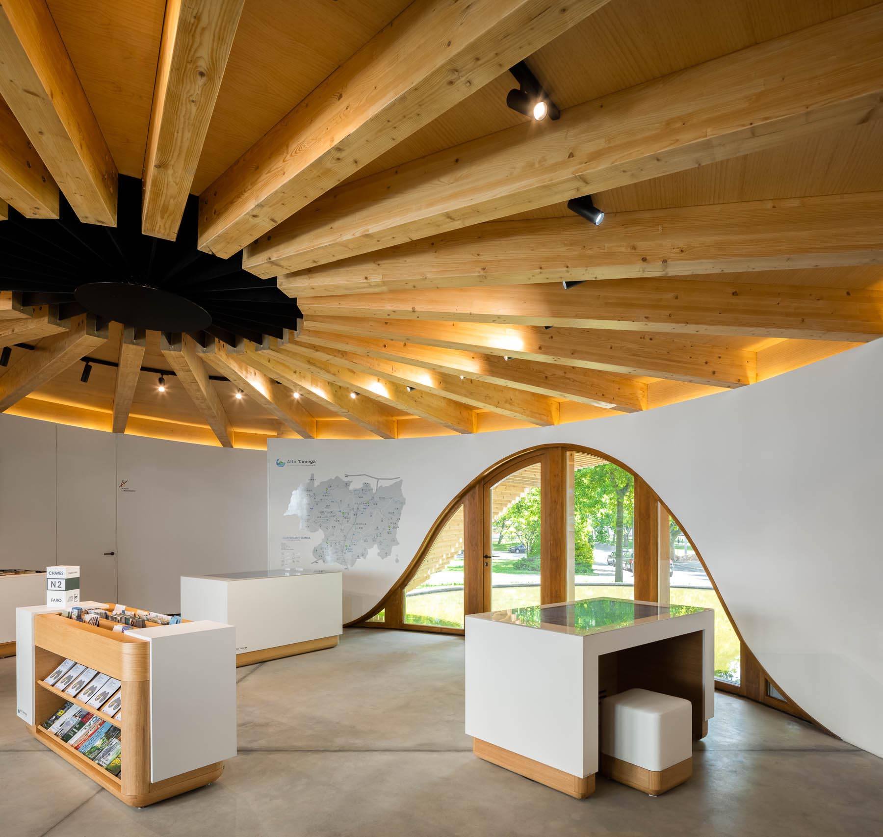 Inside this round building, there's a single open-space room with an exposed wood ceiling,