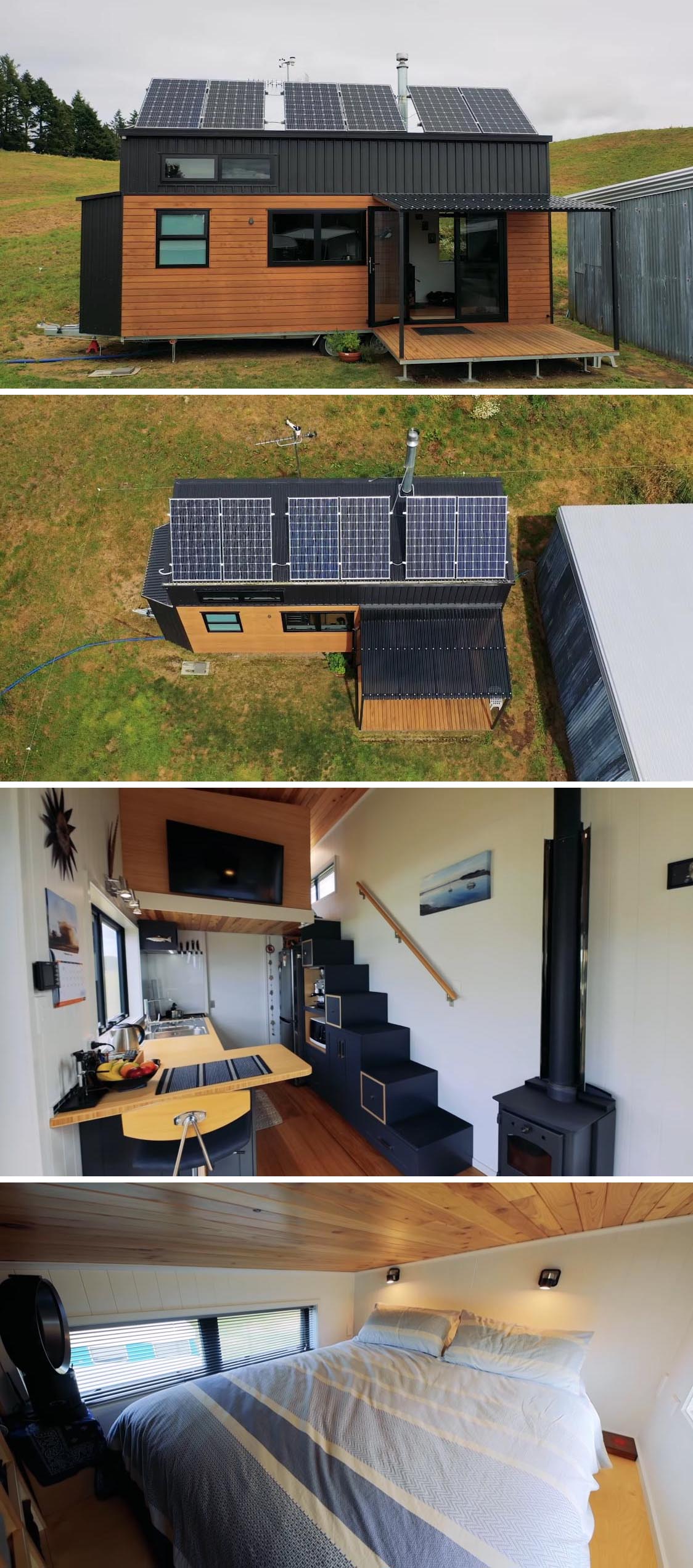 This handcrafted tiny house in New Zealand, has been designed to be off-the-grid, with solar panels and a rainwater collection system. There's also black metal and wood siding with a small covered deck, and a modern interior with lofted bedroom.