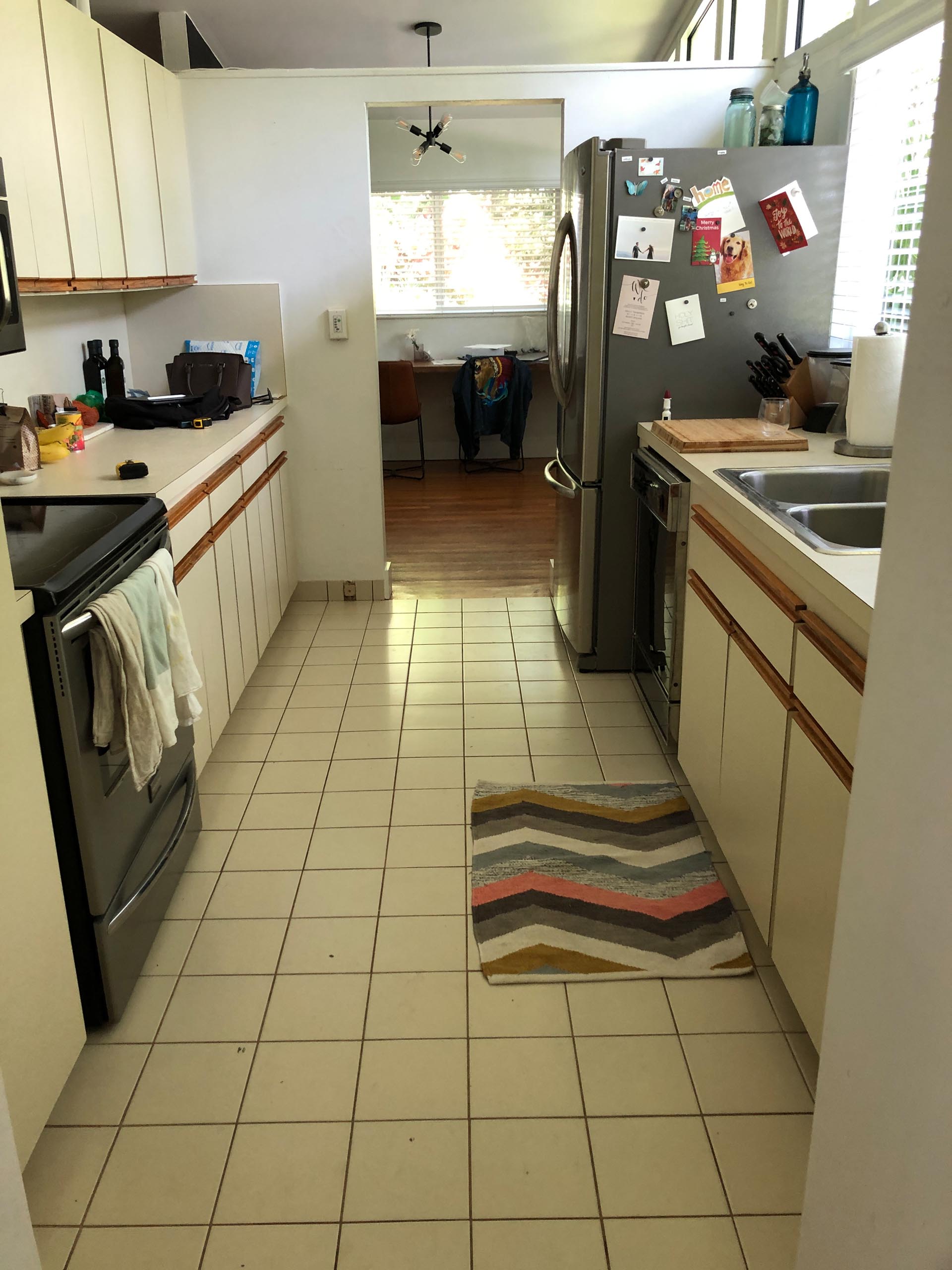 BEFORE - An enclosed and dated kitchen.