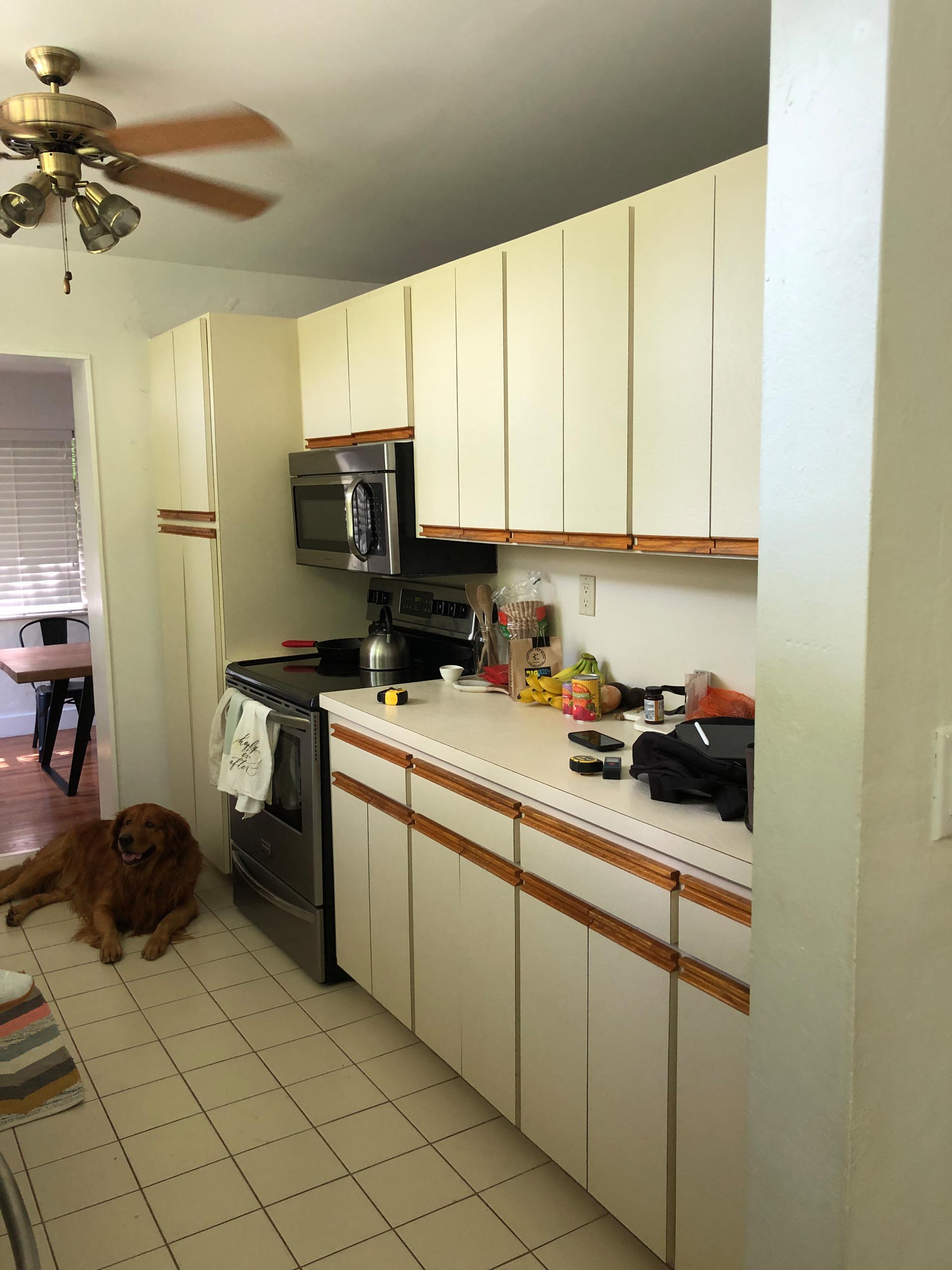 BEFORE - An enclosed and dated kitchen.