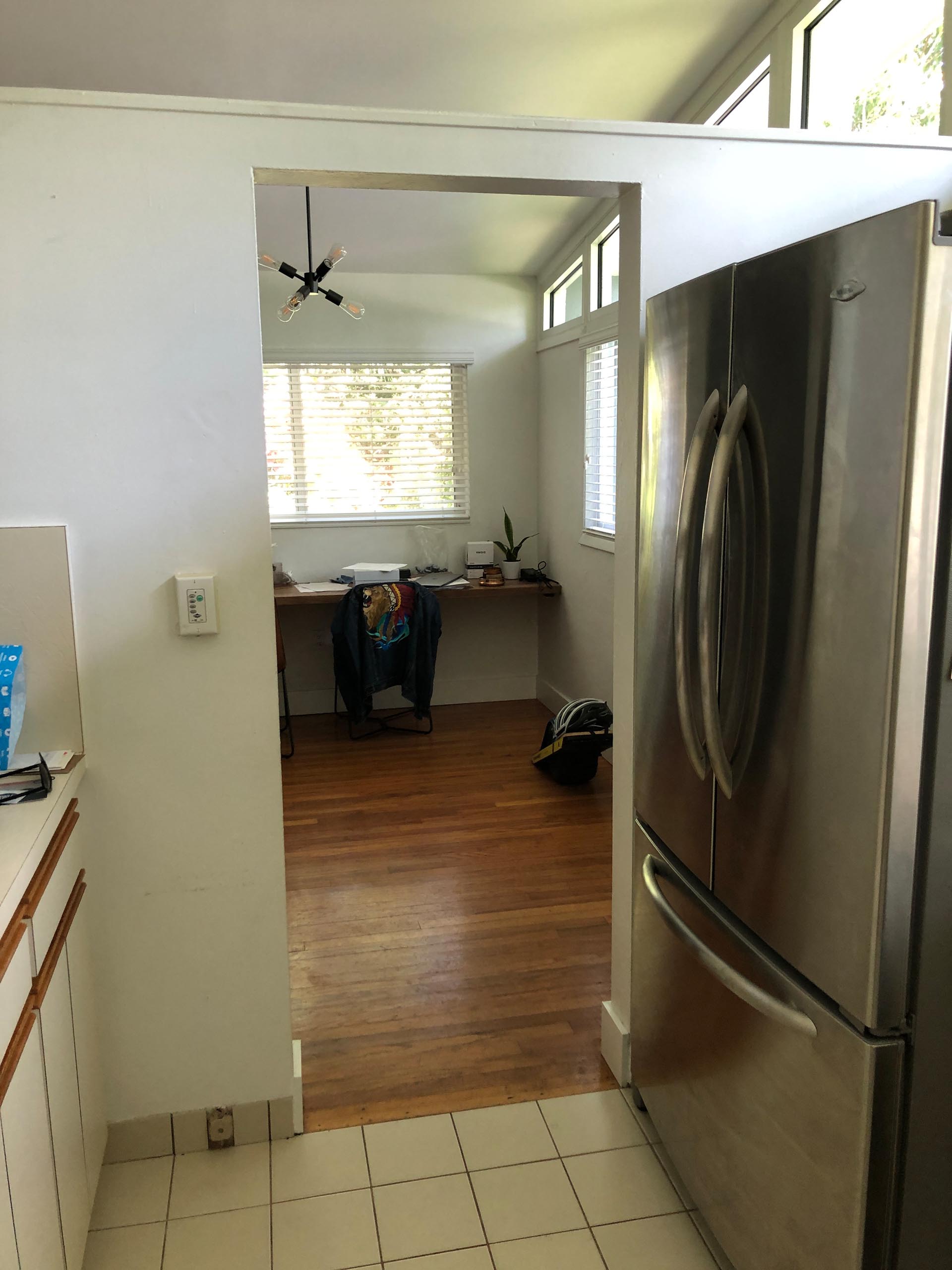 BEFORE - An enclosed and dated kitchen.