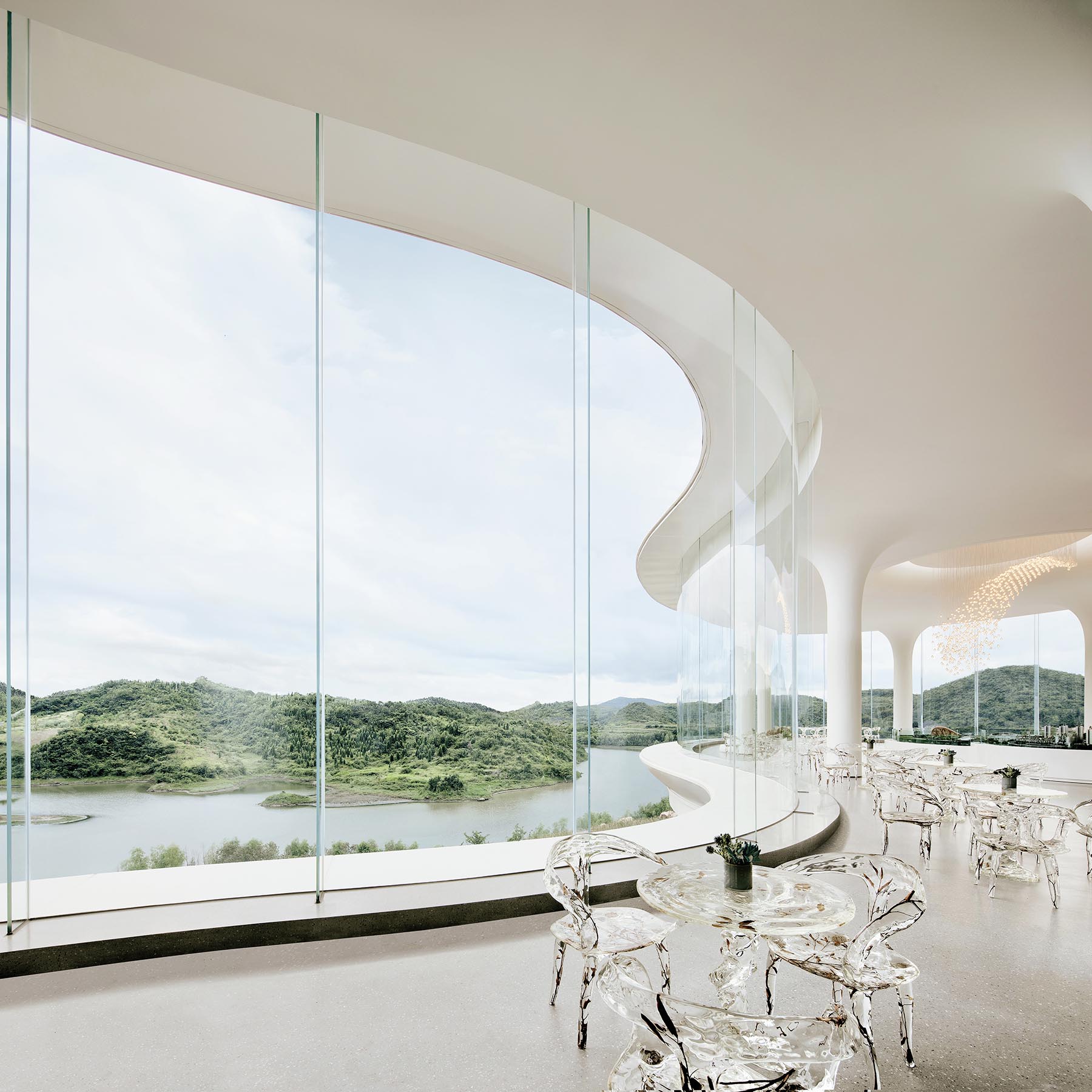 A modern sales center with tall curved glass walls.