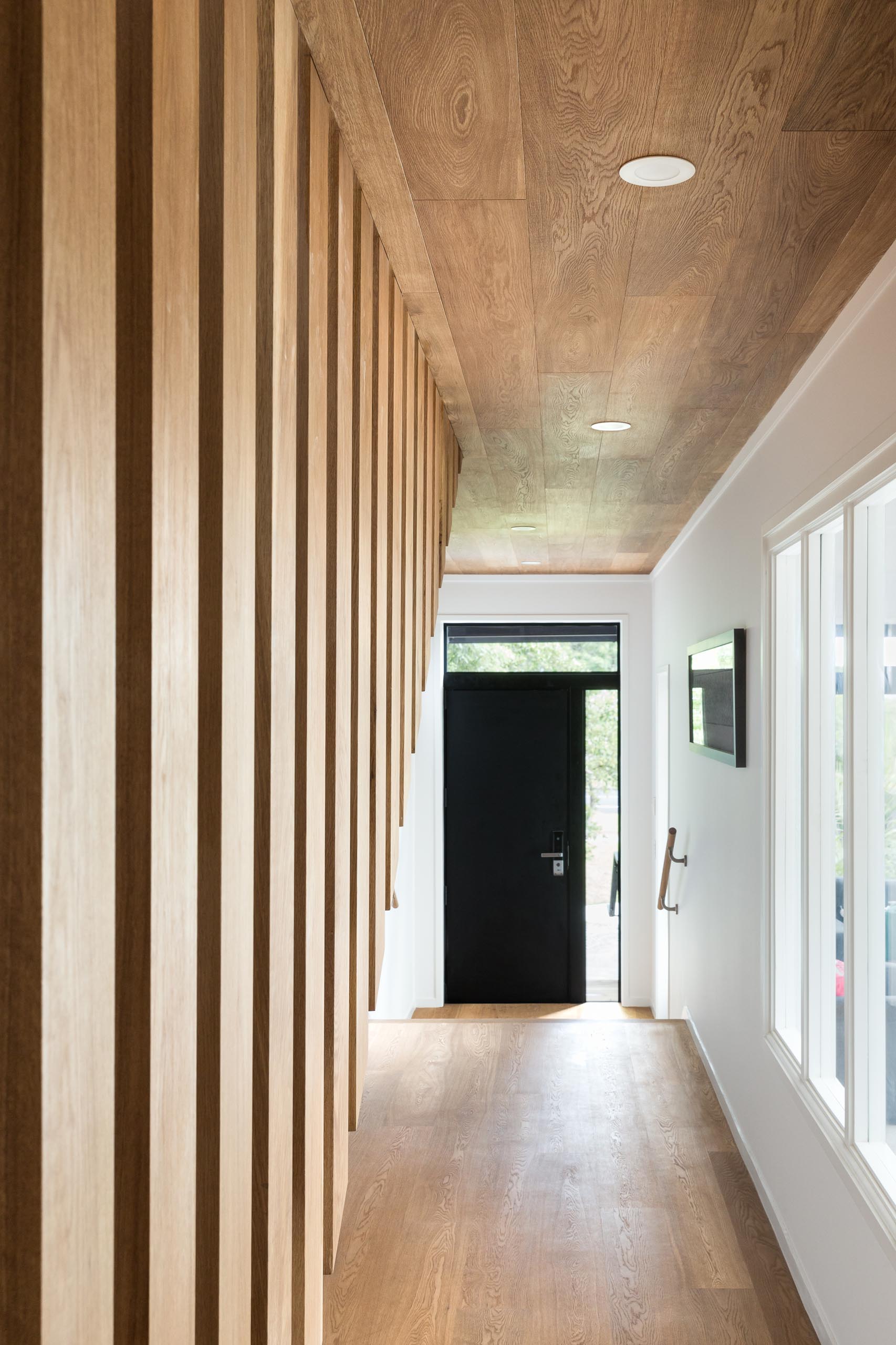 The front door opens to the entryway and hallway that has a ceiling lined with oak, adding warmth to the interior.