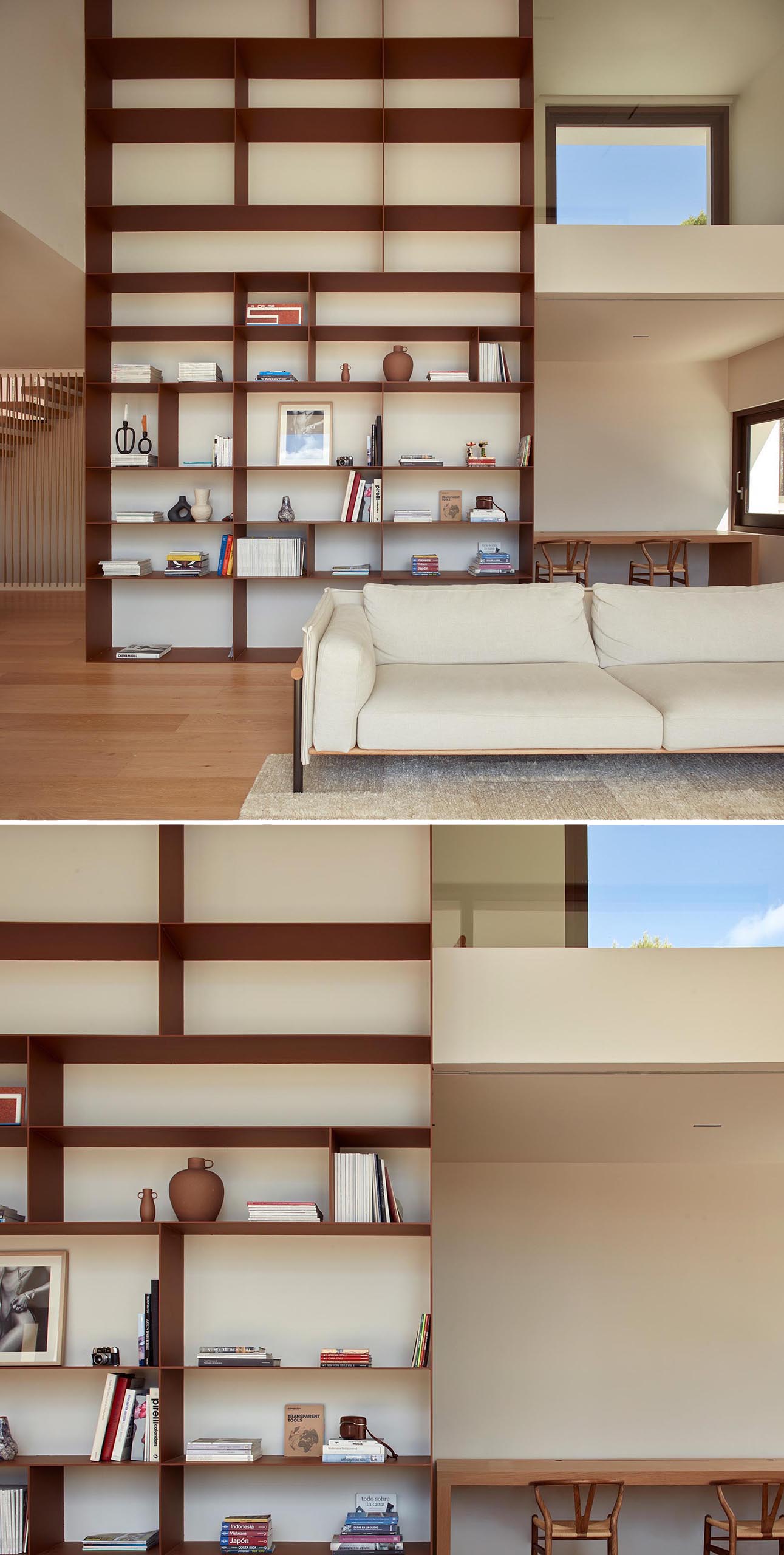 A modern living room with a double-height bookshelf.