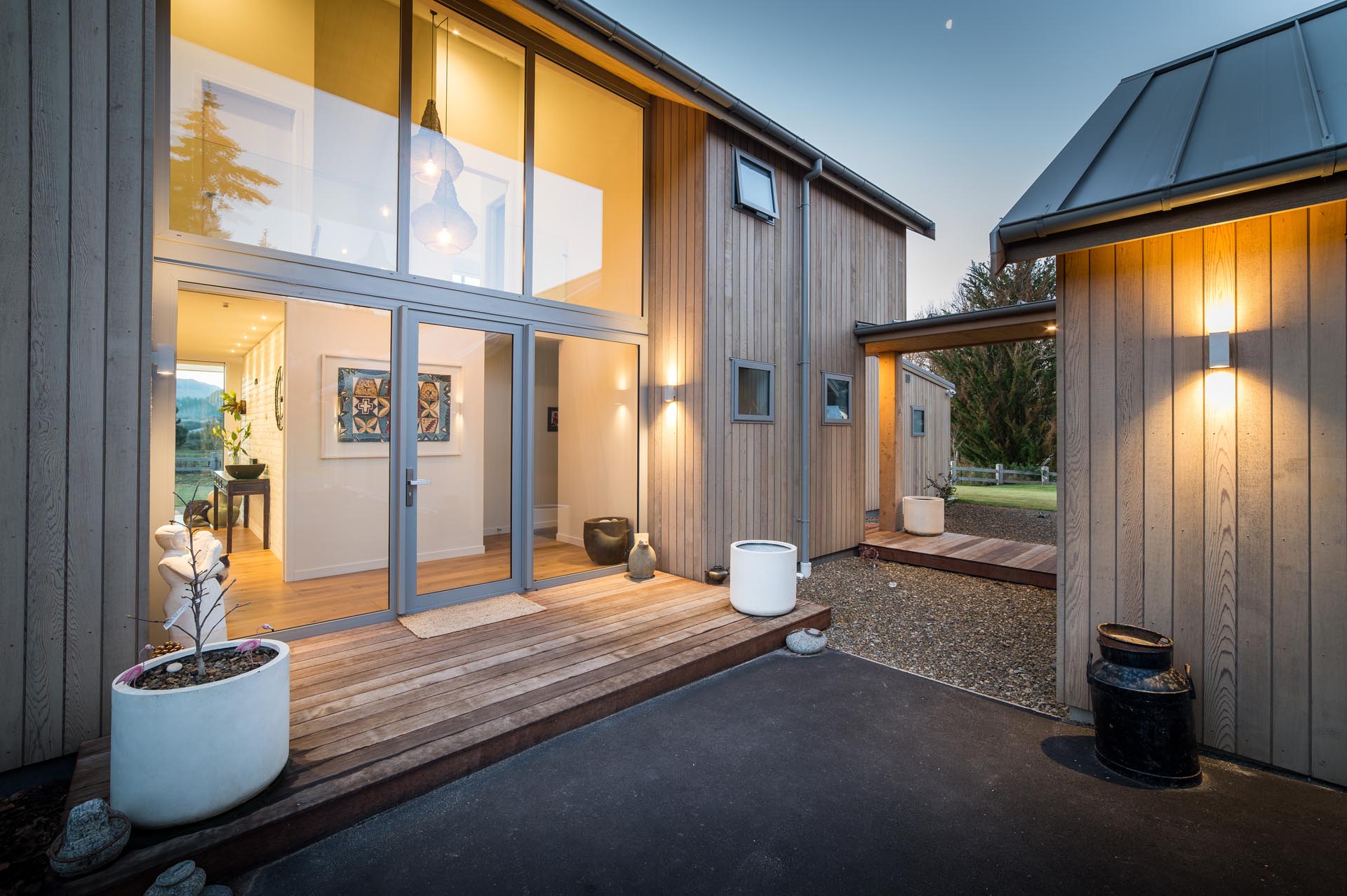 This barn-inspired home entryway is highlighted by the light that streams through the double height windows.