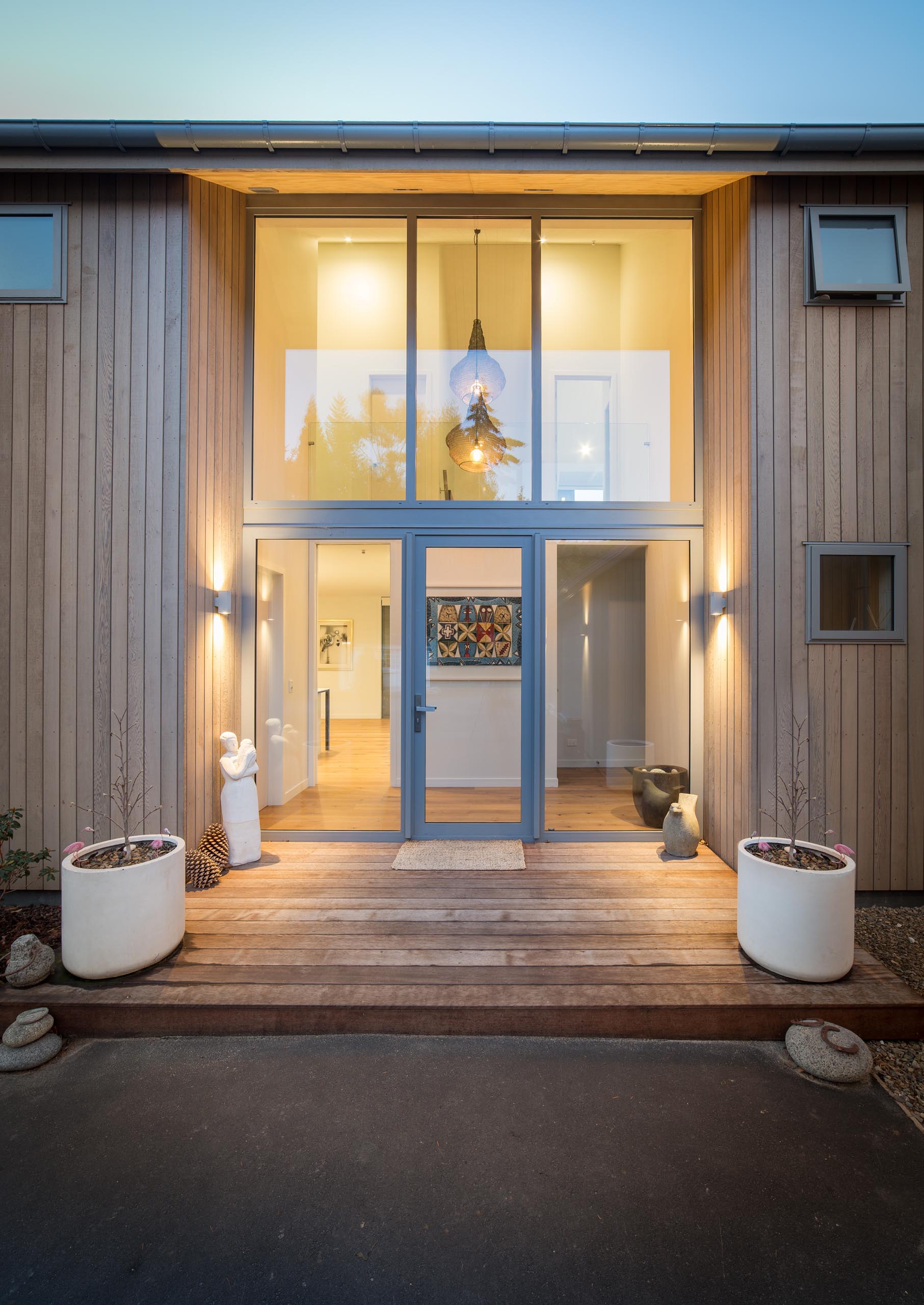 This barn-inspired home entryway is highlighted by the light that streams through the double height windows.