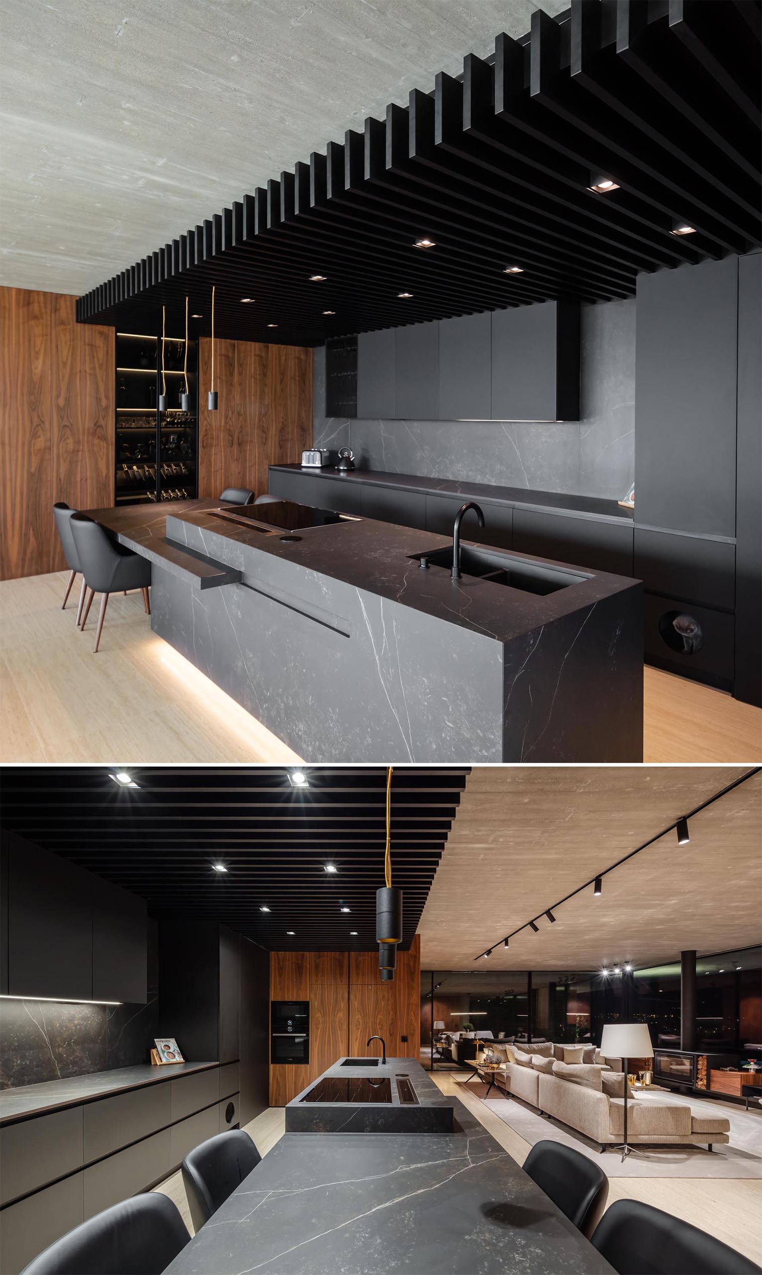 TRAMA arquitetos designed a modern concrete home in Braga, Portugal, that includes a black kitchen. 