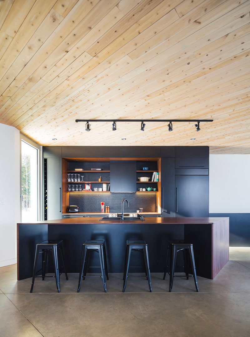 Designed by MU Architecture, this home includes a matte black kitchen and concrete floors. 