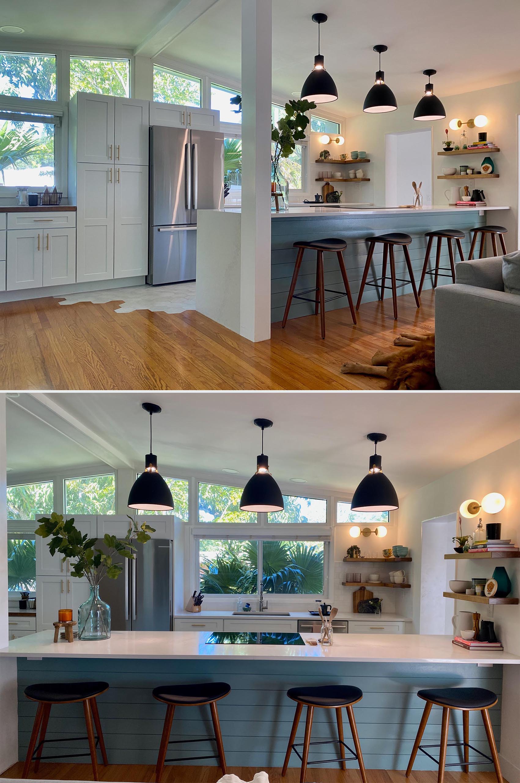 A modern and open kitchen with a peninsula, white cabinets, open wood shelving, and hexagonal floor tiles.