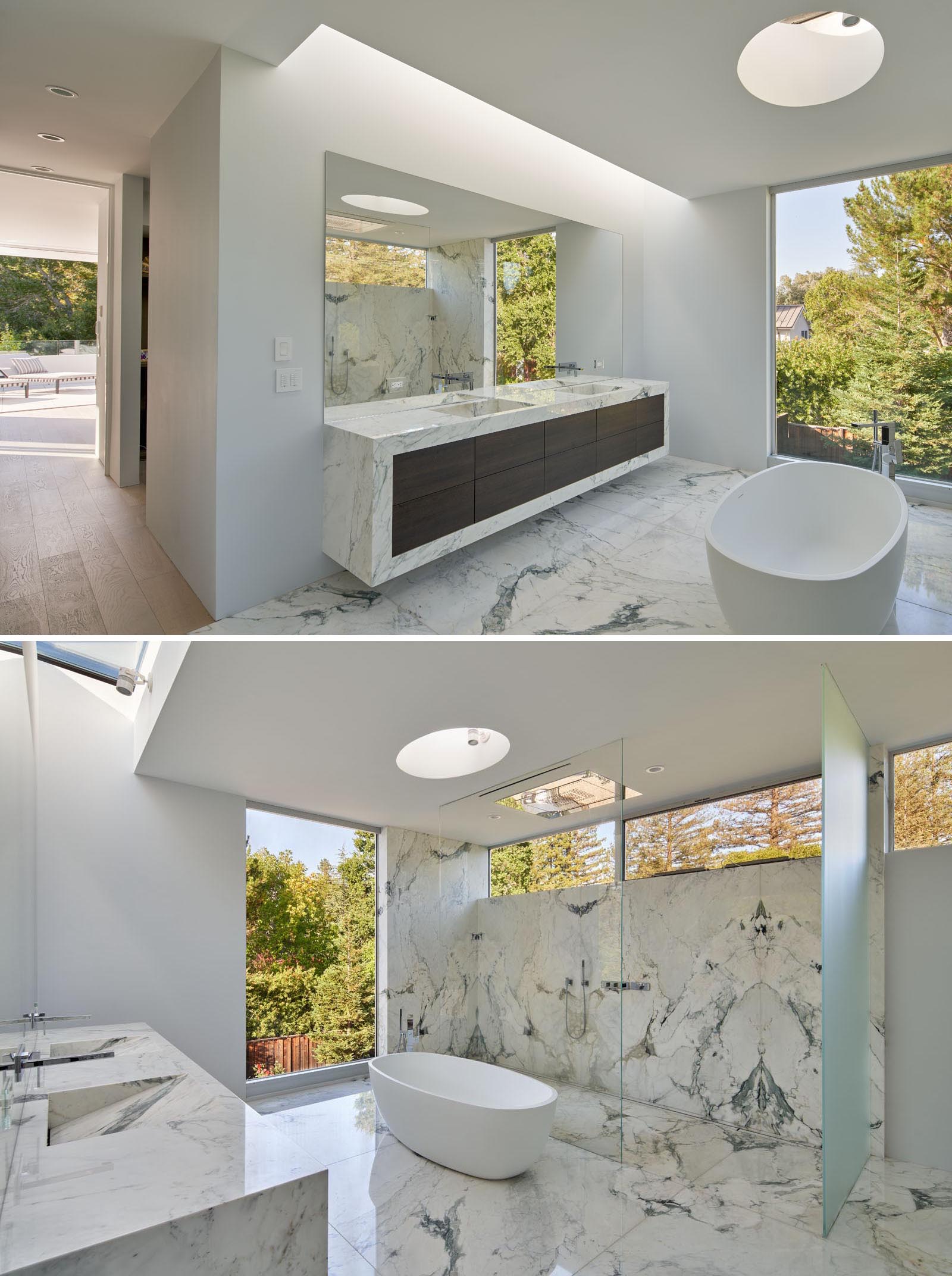 In the master bathroom, there's a double vanity, a freestanding bathtub, and a large walk-in shower.