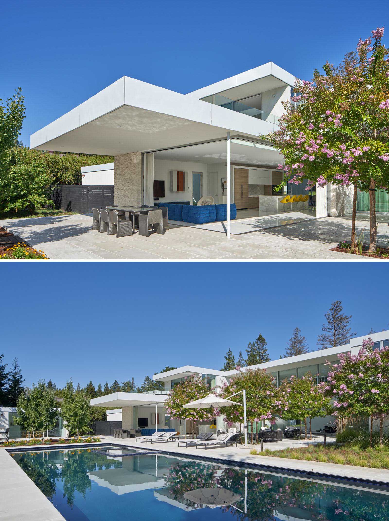 The outdoor spaces of this modern house include a covered dining patio, an lounge area, and a swimming pool.