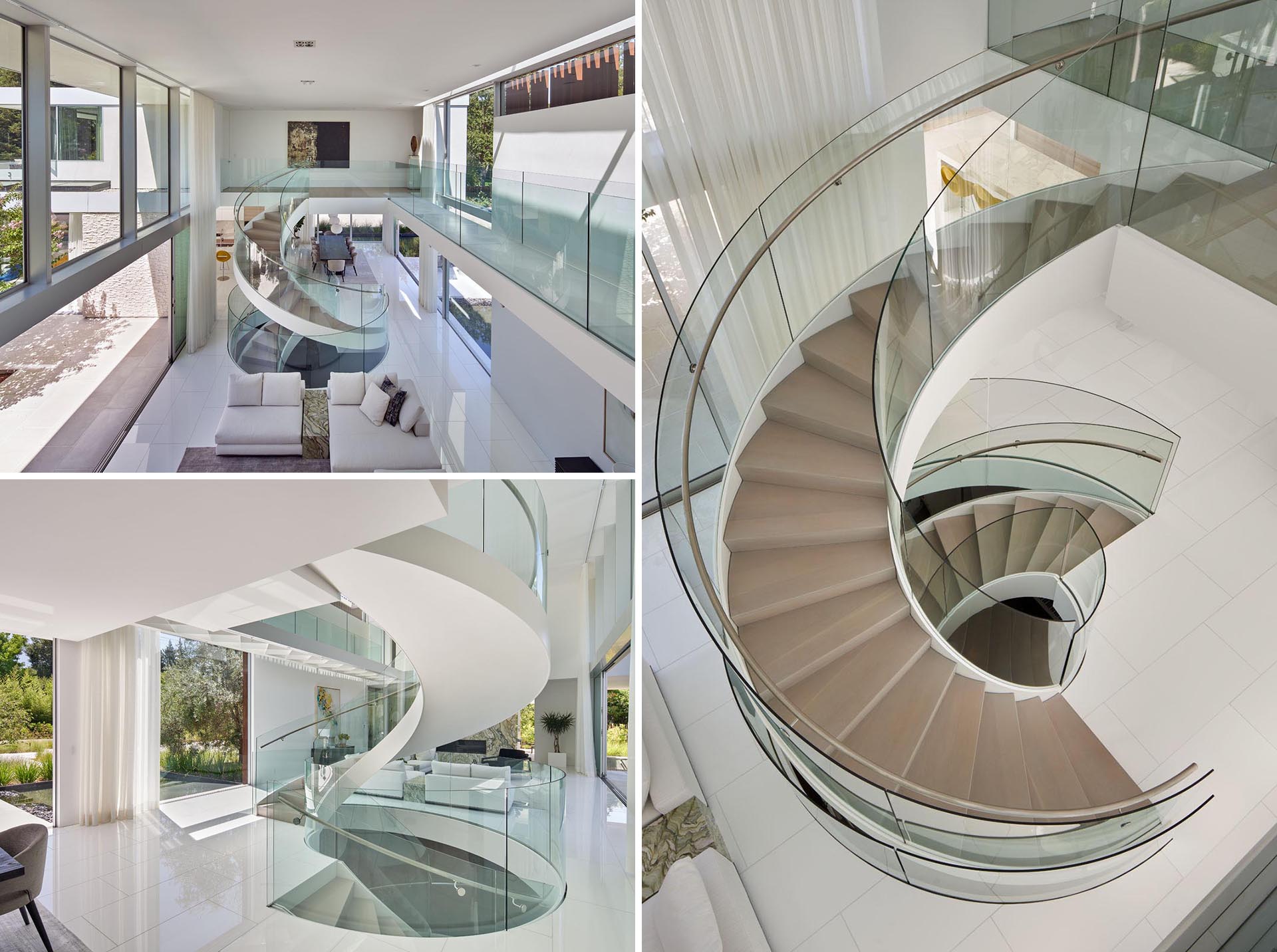 This custom designed spiral staircase includes glass handrails and a steel frame that complements the surrounding white walls.