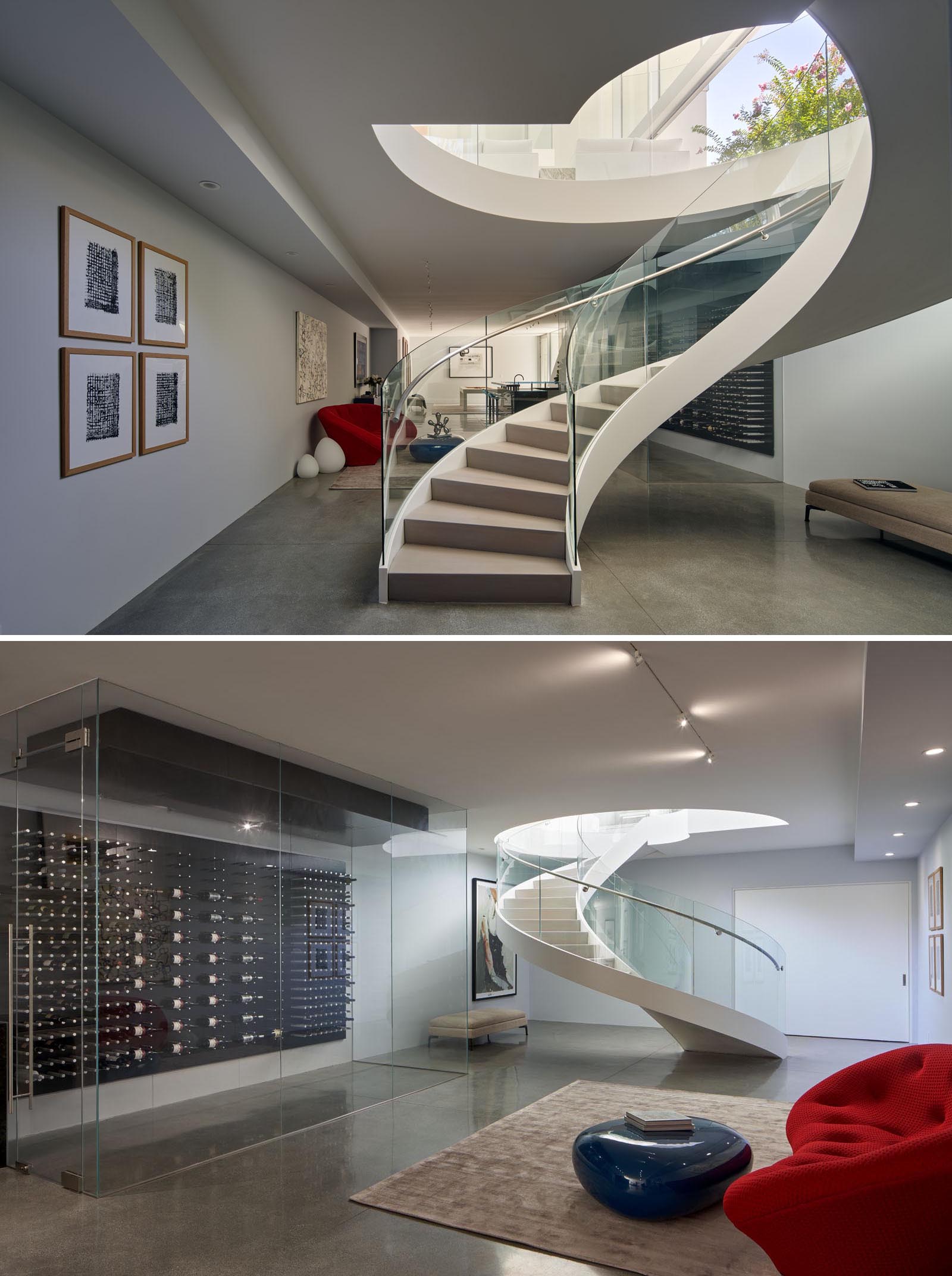 At the bottom of these spiral stairs is the basement that features concrete flooring, a casual lounge, and a wine storage wall.