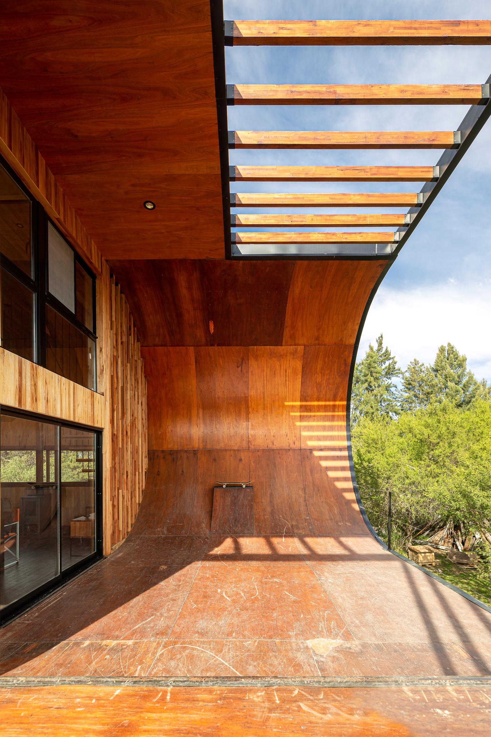 A small and modern house with a built-in skateboard ramp.