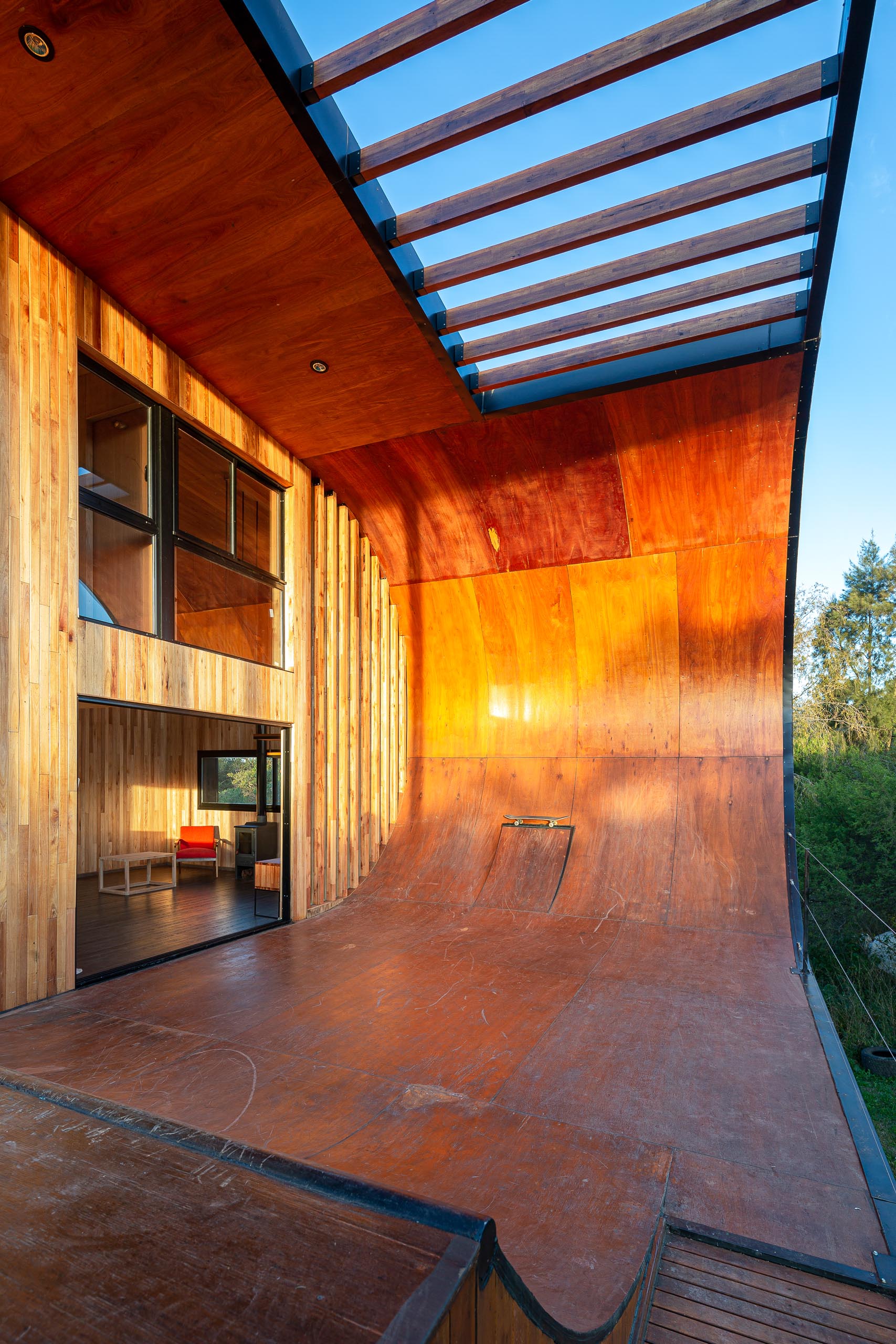 A small and modern house with a built-in skateboard ramp.