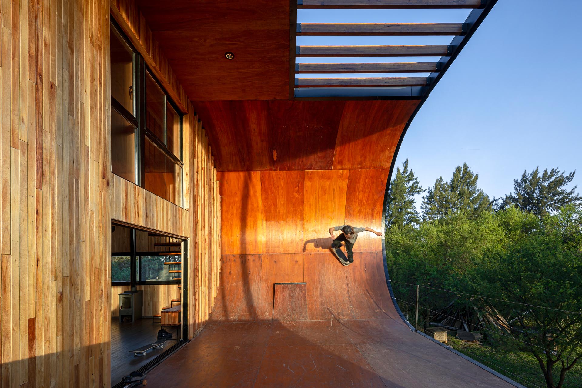 A small and modern house with a built-in skateboard ramp.