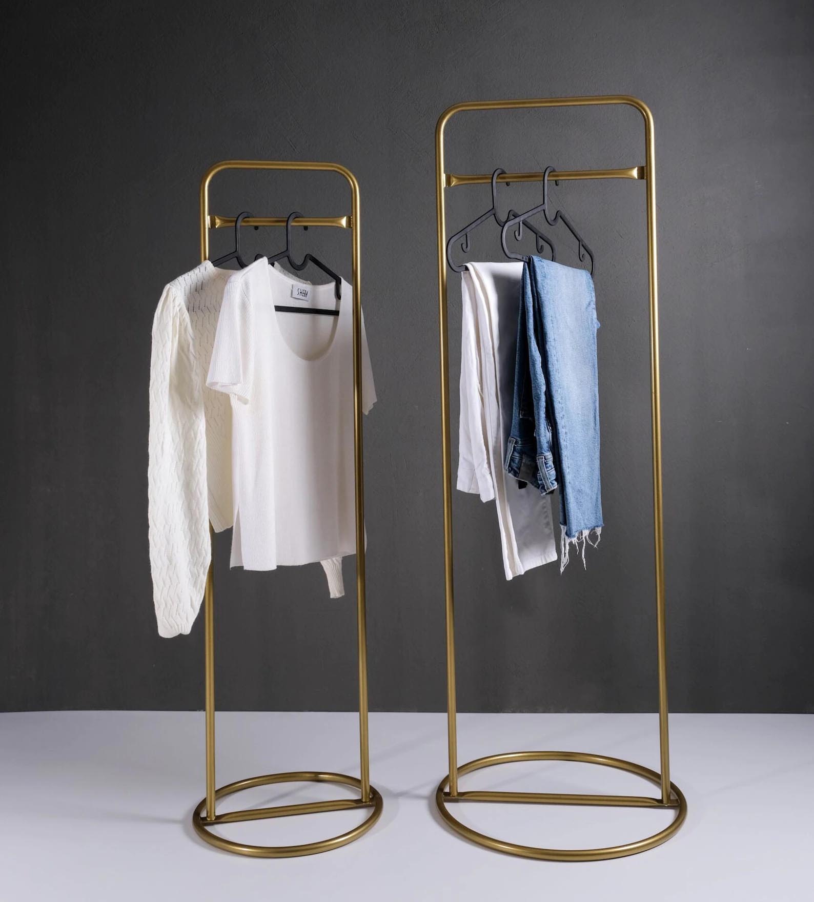 Storage Idea - Modern freestanding gold clothes rack with round base.