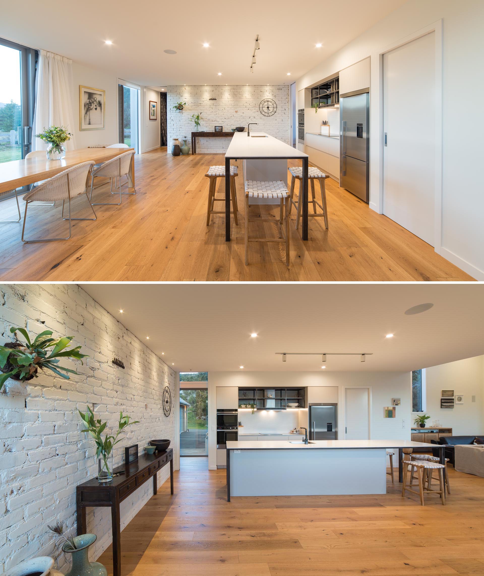 An open plan kitchen and dining area that had a white painted brick wall.