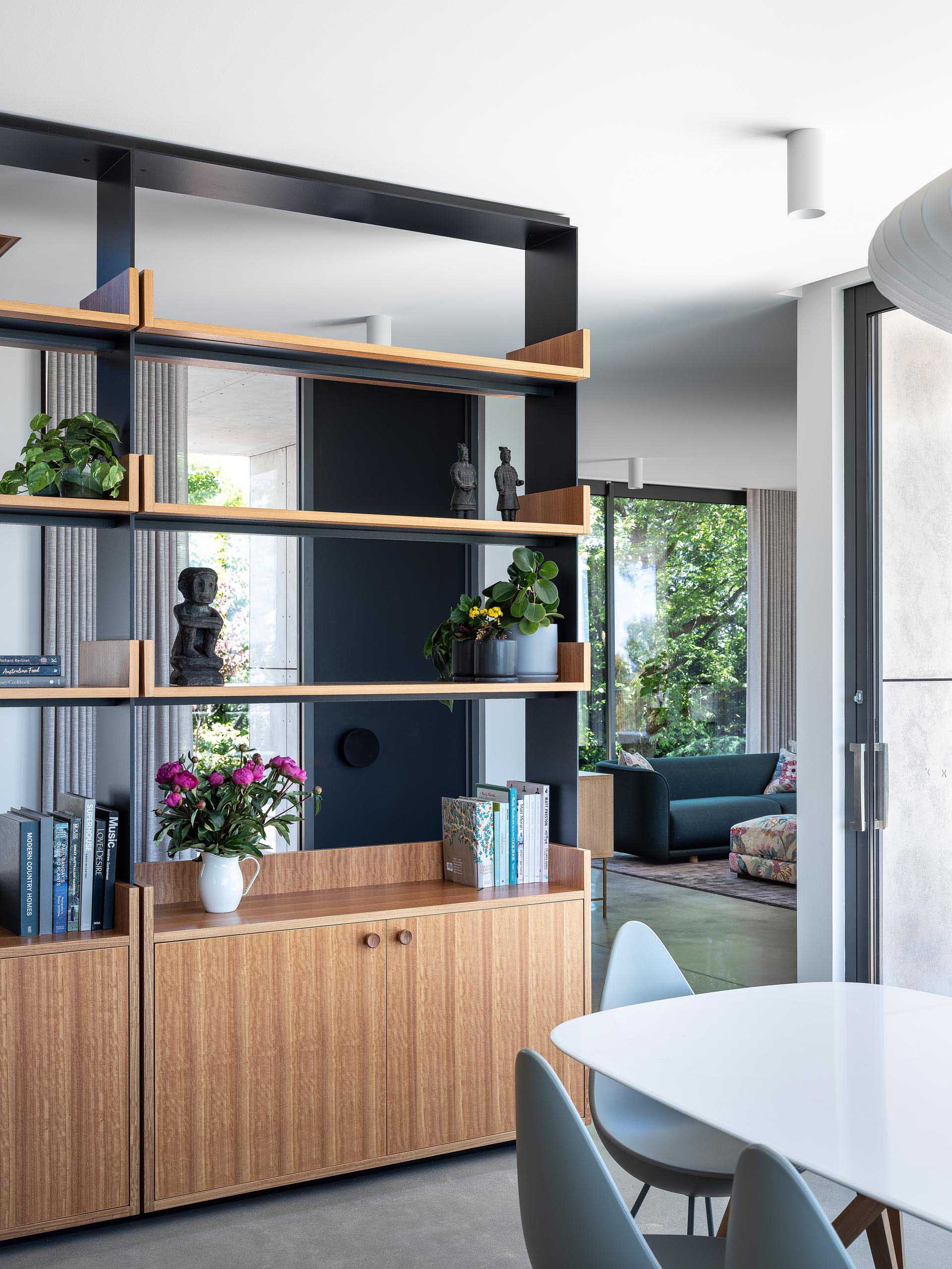 The blackbutt timber was also used to create lower cabinets, adding storage to the dining room. The shelving unit also allows the natural light from the windows to pass through, creating an open and bright interior.