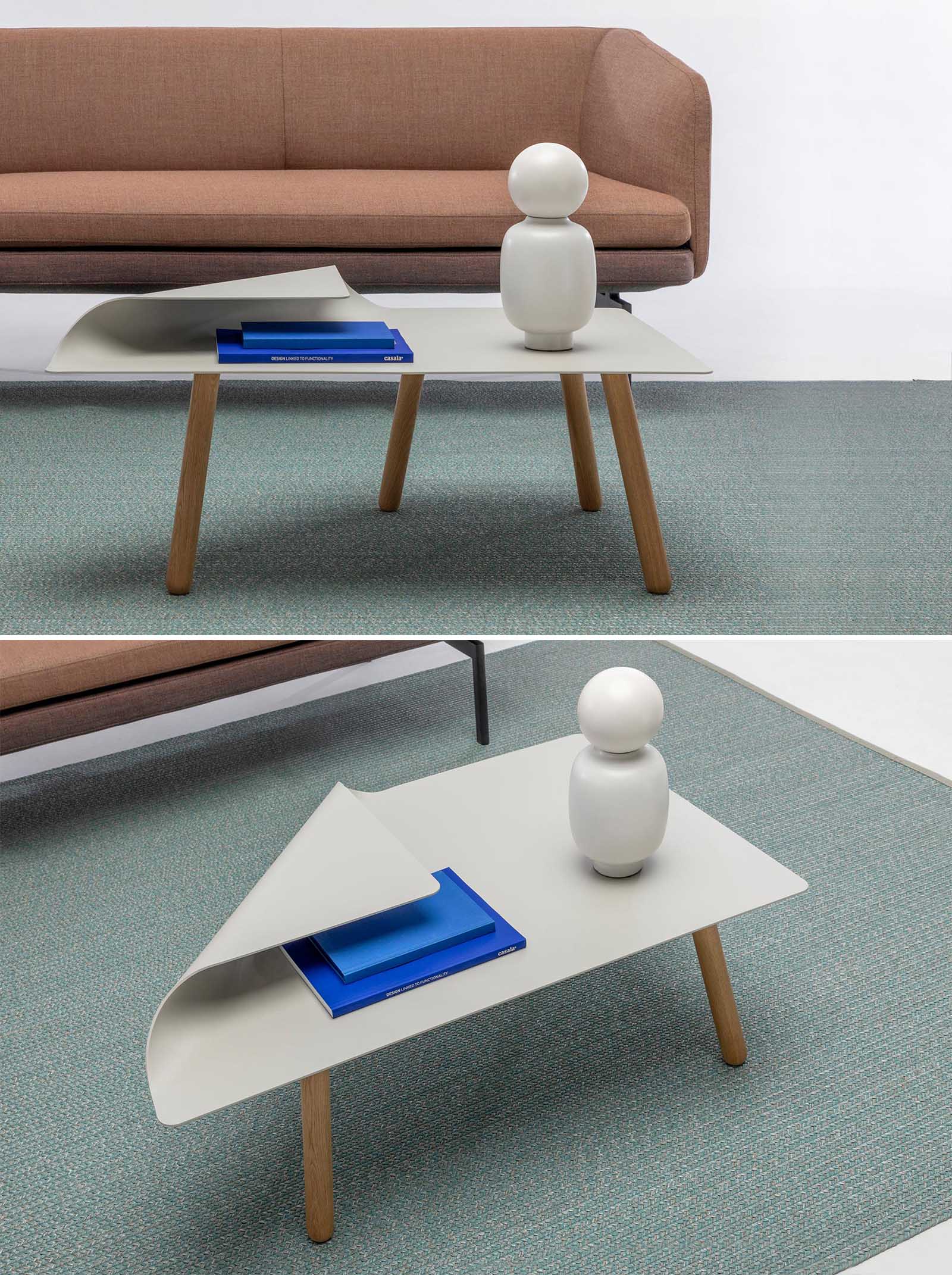 A modern side table (or coffee table) with solid oak legs and a folded steel top that creates a second level.