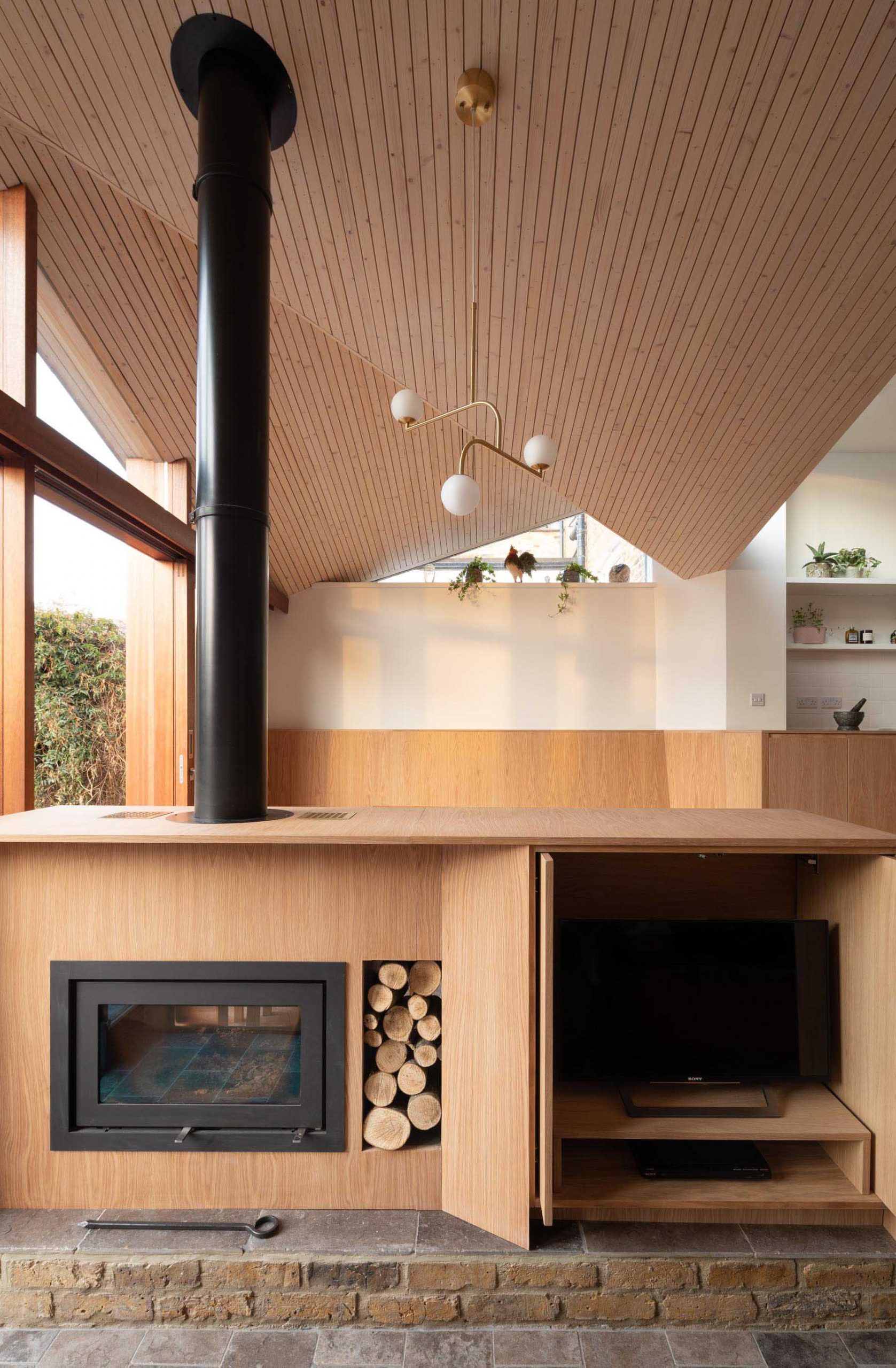 A modern interior with a fireplace and TV hidden within a cabinet.