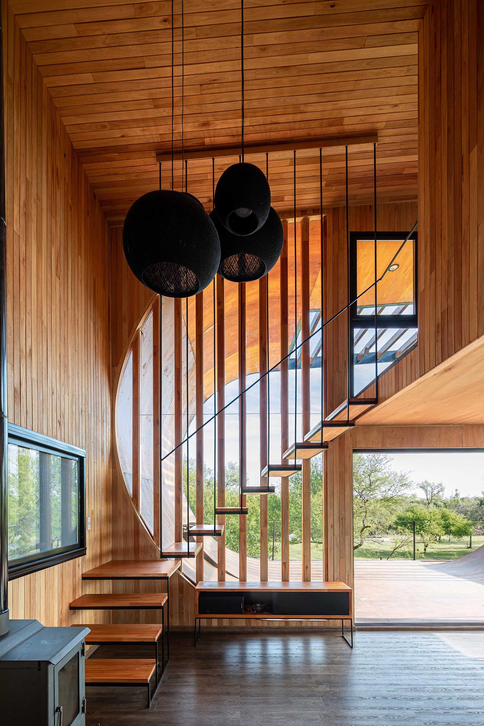 A modern house with wood stairs and a skateboard ramp.