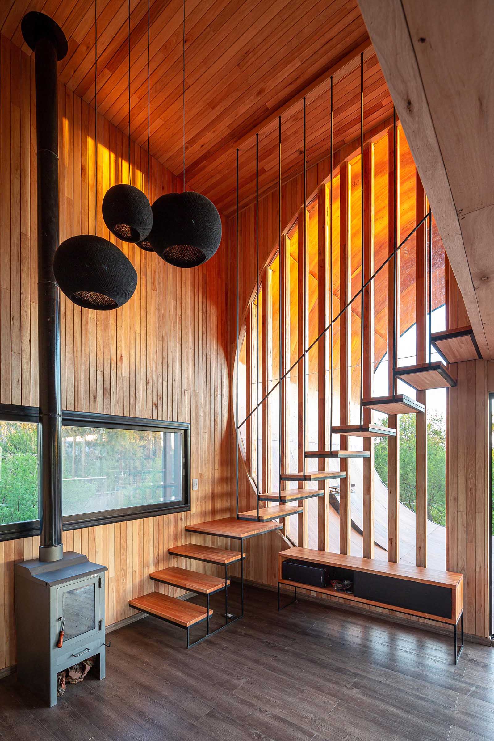 A modern house with wood stairs and a skateboard ramp.