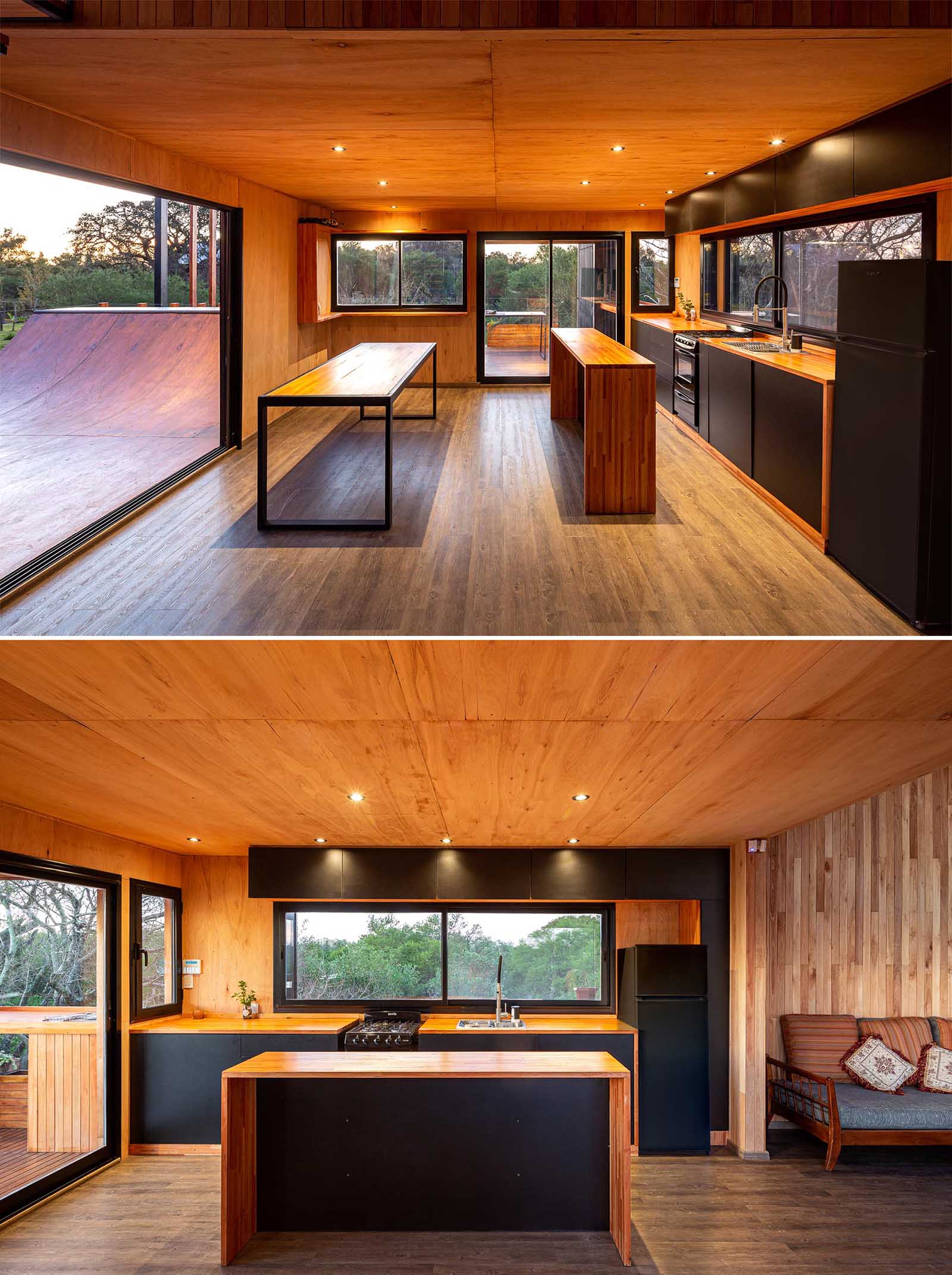 A modern house with a wood and black kitchen and dining area, and a skateboard ramp.