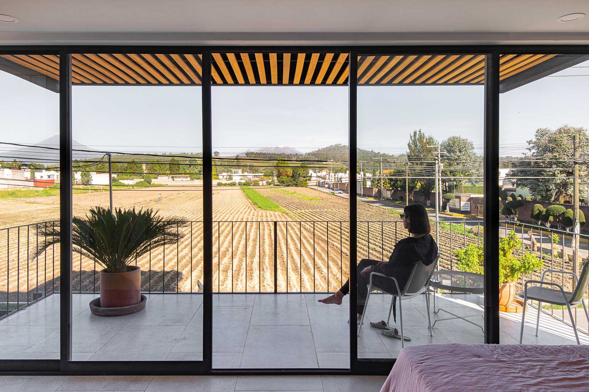 A modern apartment balcony with views of the neighborhood.