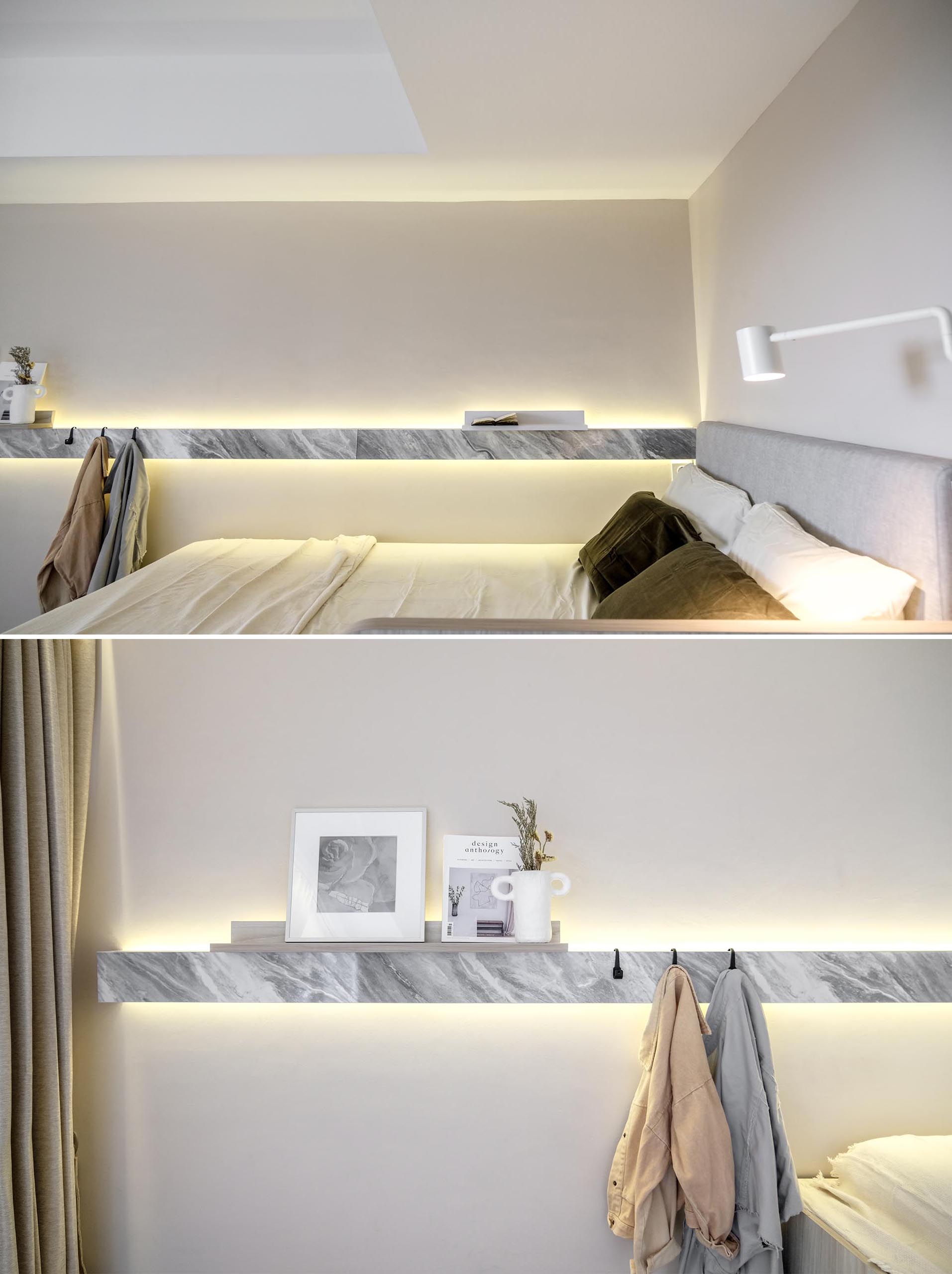 Running along the length of the bed in this micro apartment, is a small linear shelf that includes hidden lighting, allowing a soft glow to line the wall.