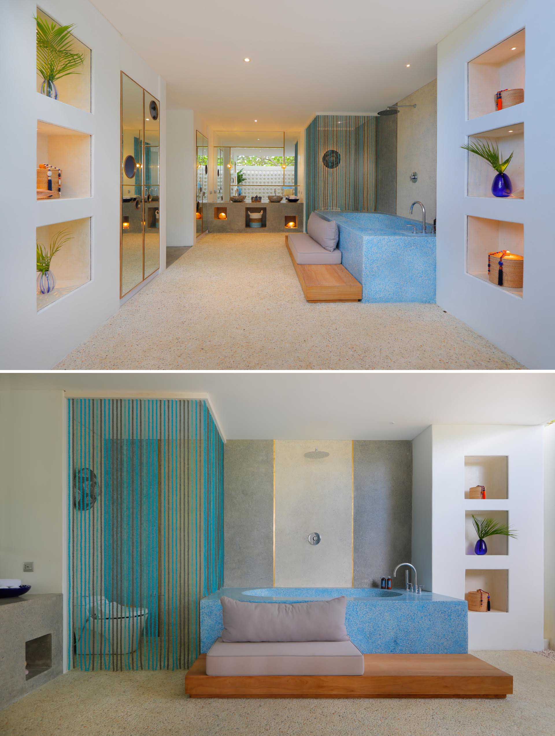 A modern beach house bathroom with a built-in bathtub, and shelving niches.