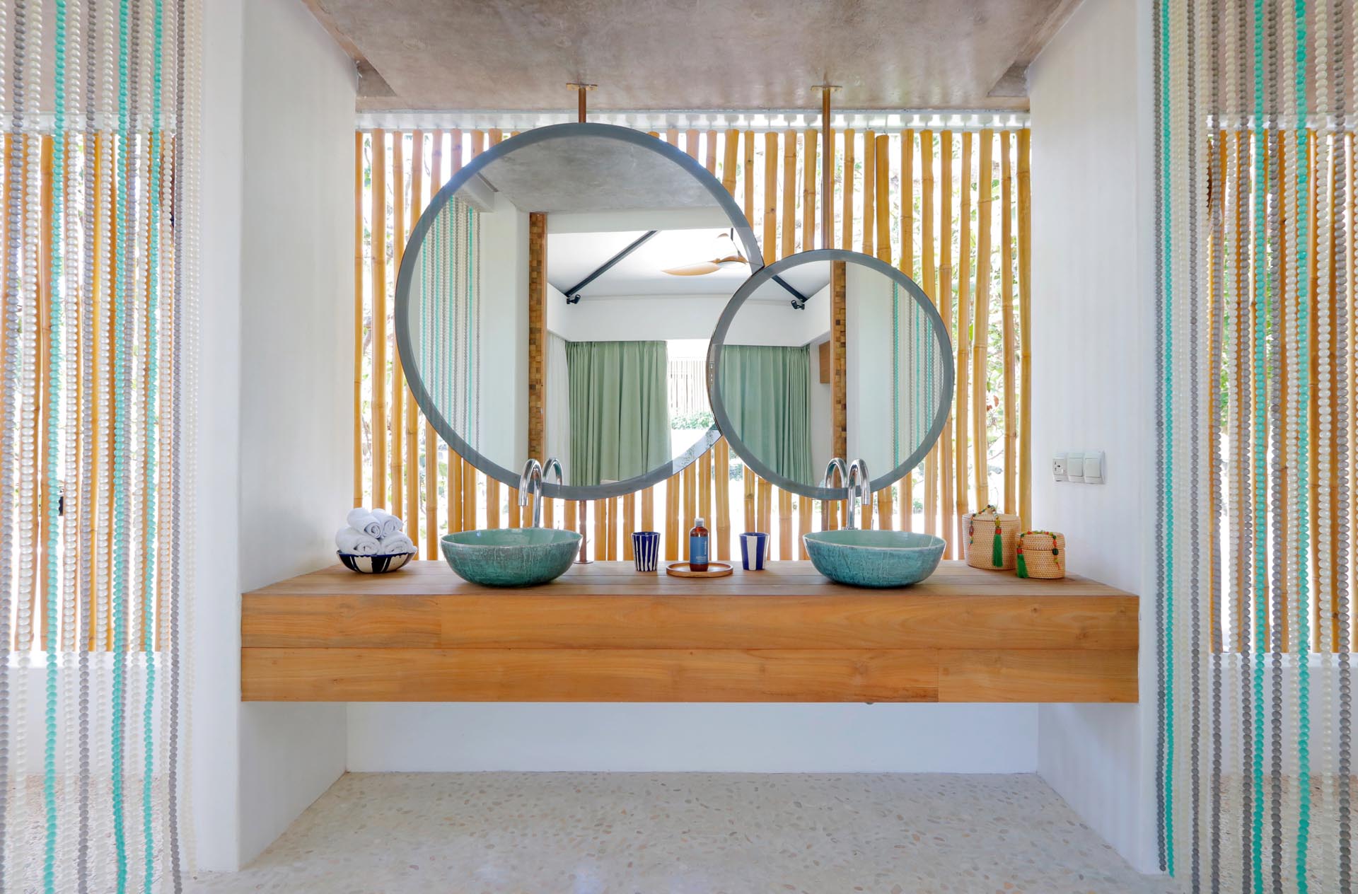 A modern bathroom with bamboo screens adds a natural design element that also provides privacy.