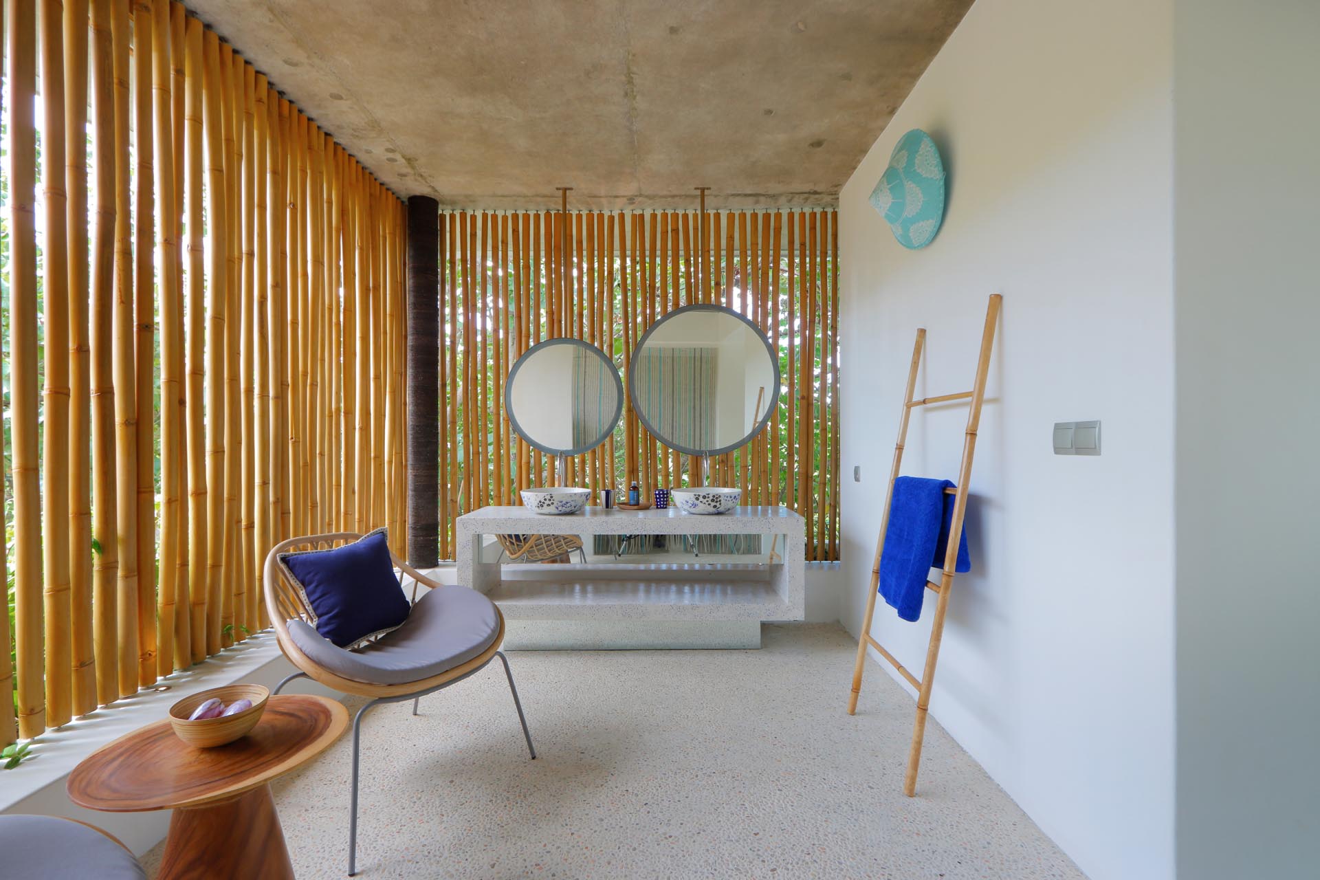 A modern bathroom with bamboo screens adds a natural design element that also provides privacy.