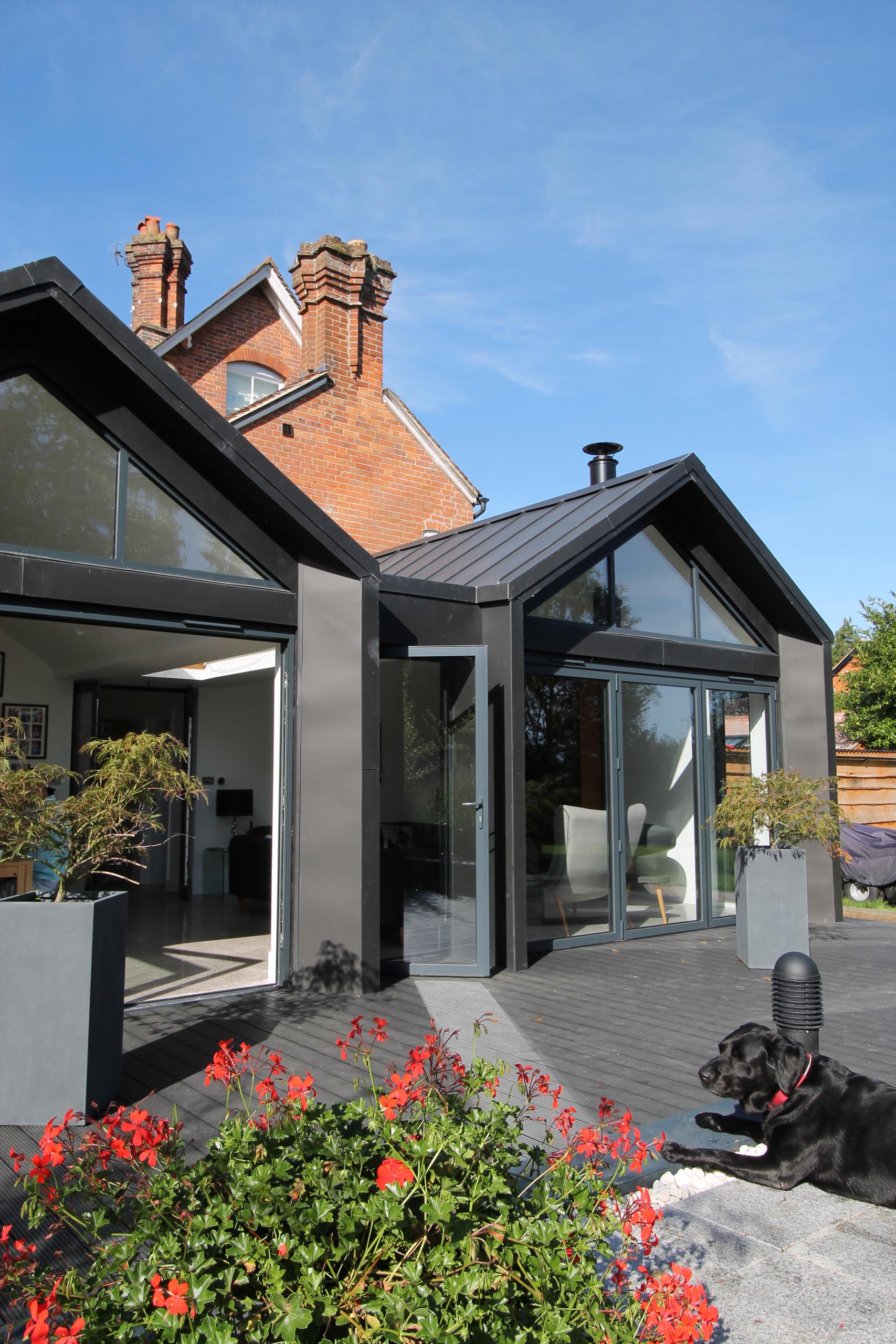 Folding doors allow this modern extension to be opened up to the deck area and countryside views, while windows add plenty of natural light.