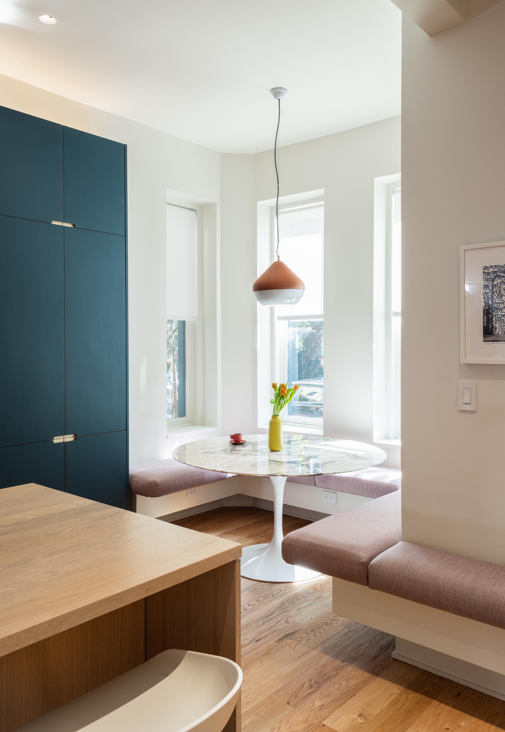 A modern built-in breakfast nook with upholstered benches.