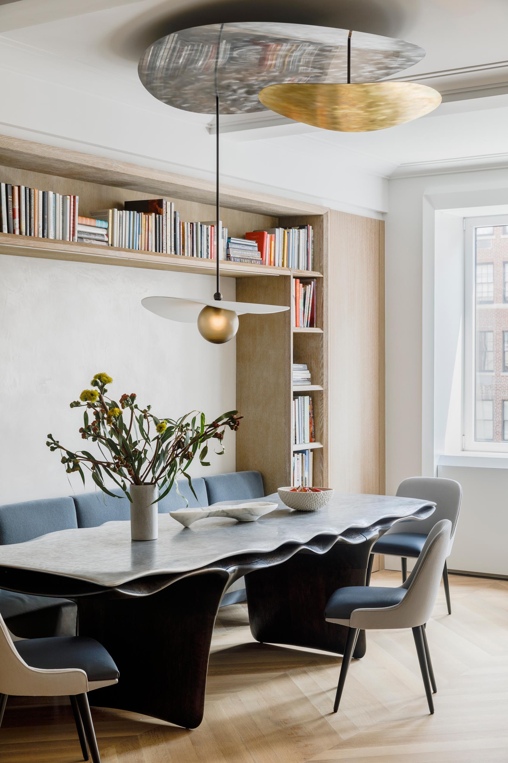 Within this dining room, chairs fit perfectly within the surrounding millwork, allowing them to act as a bench or break apart into chairs.