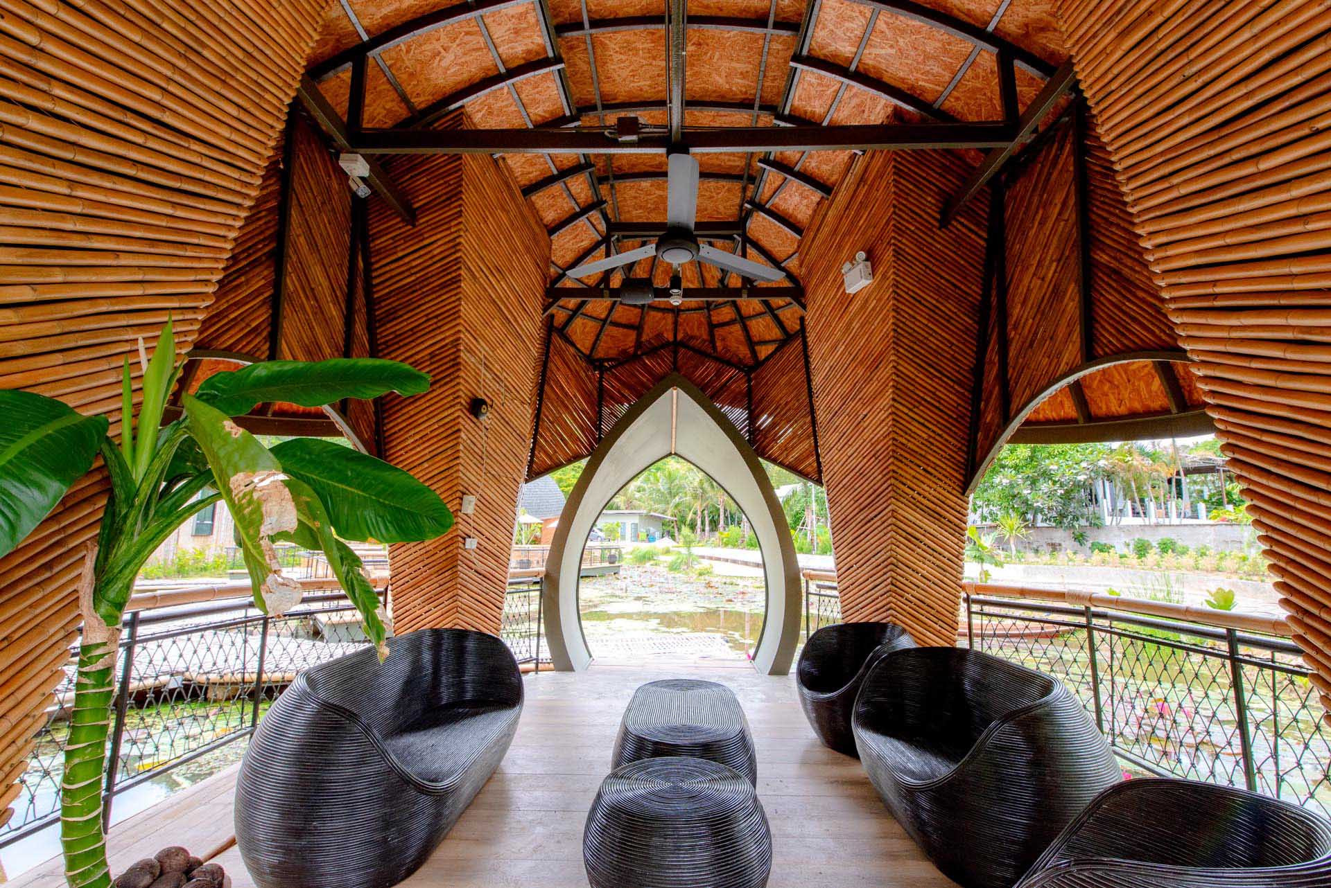 A modern eco-lodge in Thailand, that has cabins shaped like turtle shells that surround a lotus pond.