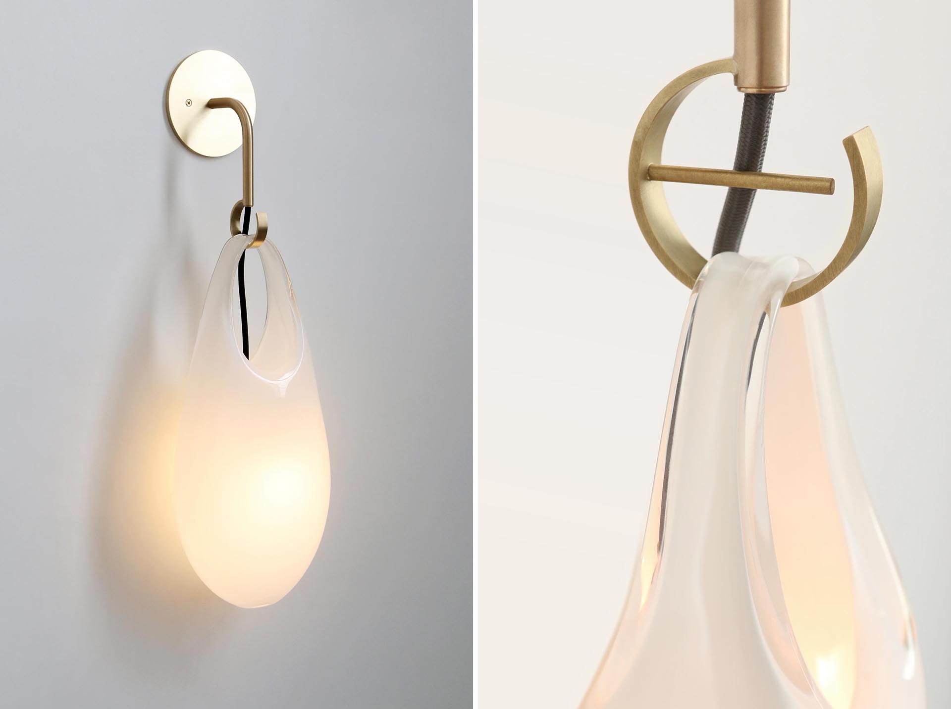 The Hold pendant lights and sconces, are modern handblown glass lights that look like they're hanging from hooks.