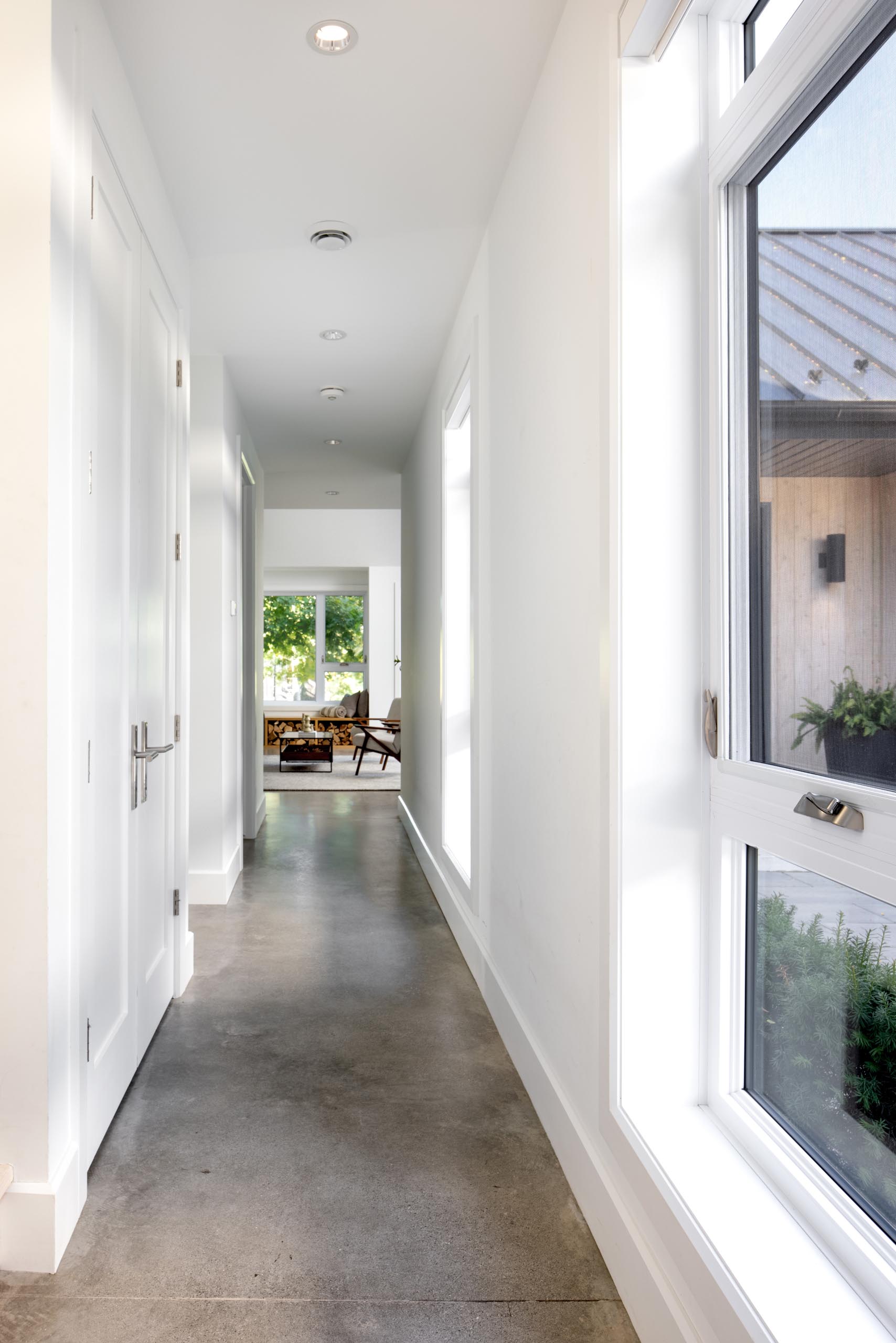 Polished concrete floors are featured throughout this Scandinavian inspired home, like in the hallway.