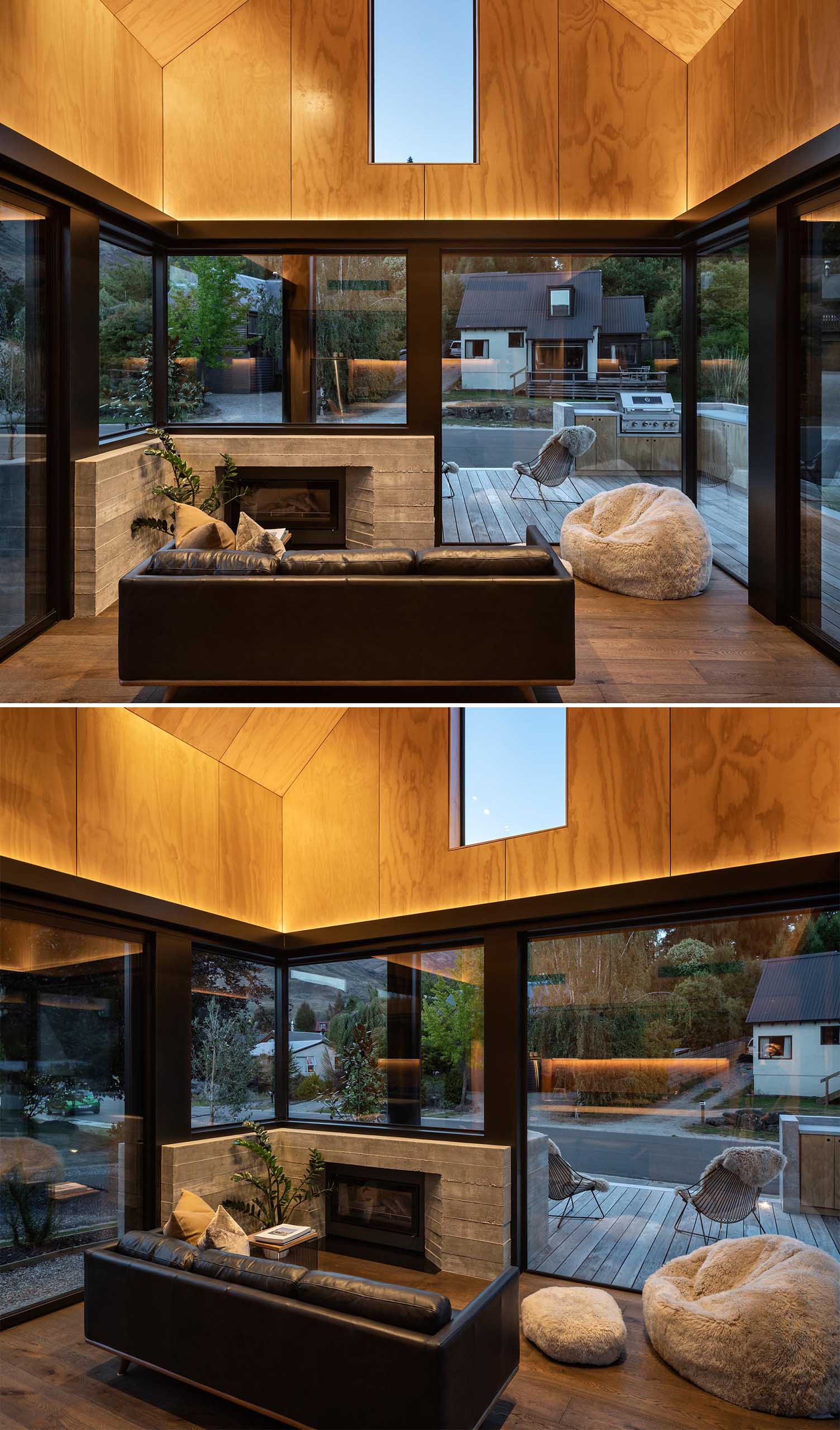 The lower floor of this small home contains a double-height living and kitchen space, with hidden lighting that highlights the wood ceiling. 