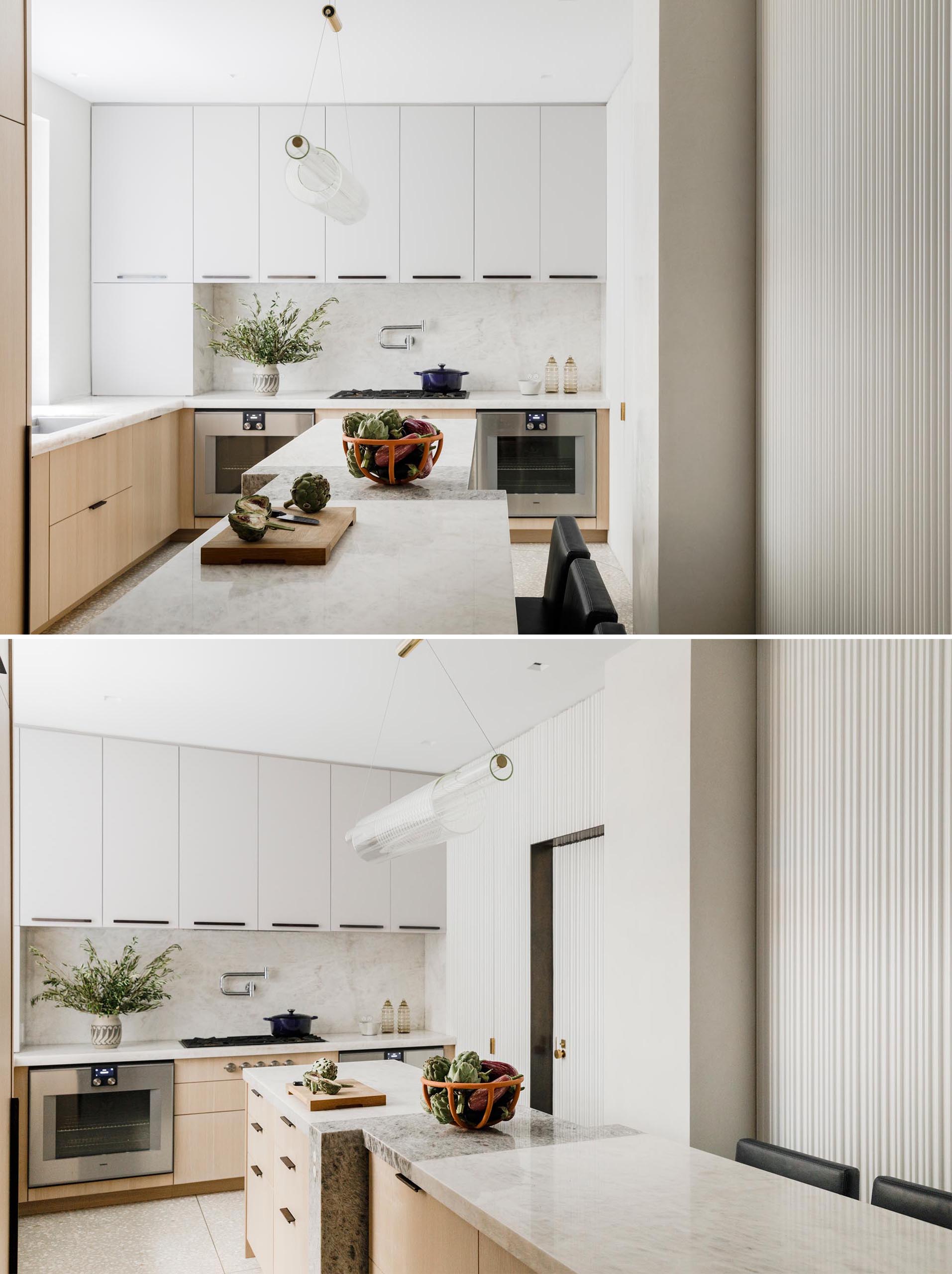 Within this modern kitchen there's cabinetry designed is by Henrybuilt, with additional customization by MKCA. The countertops are white Cristallo quartz and the floor is terrazzo.