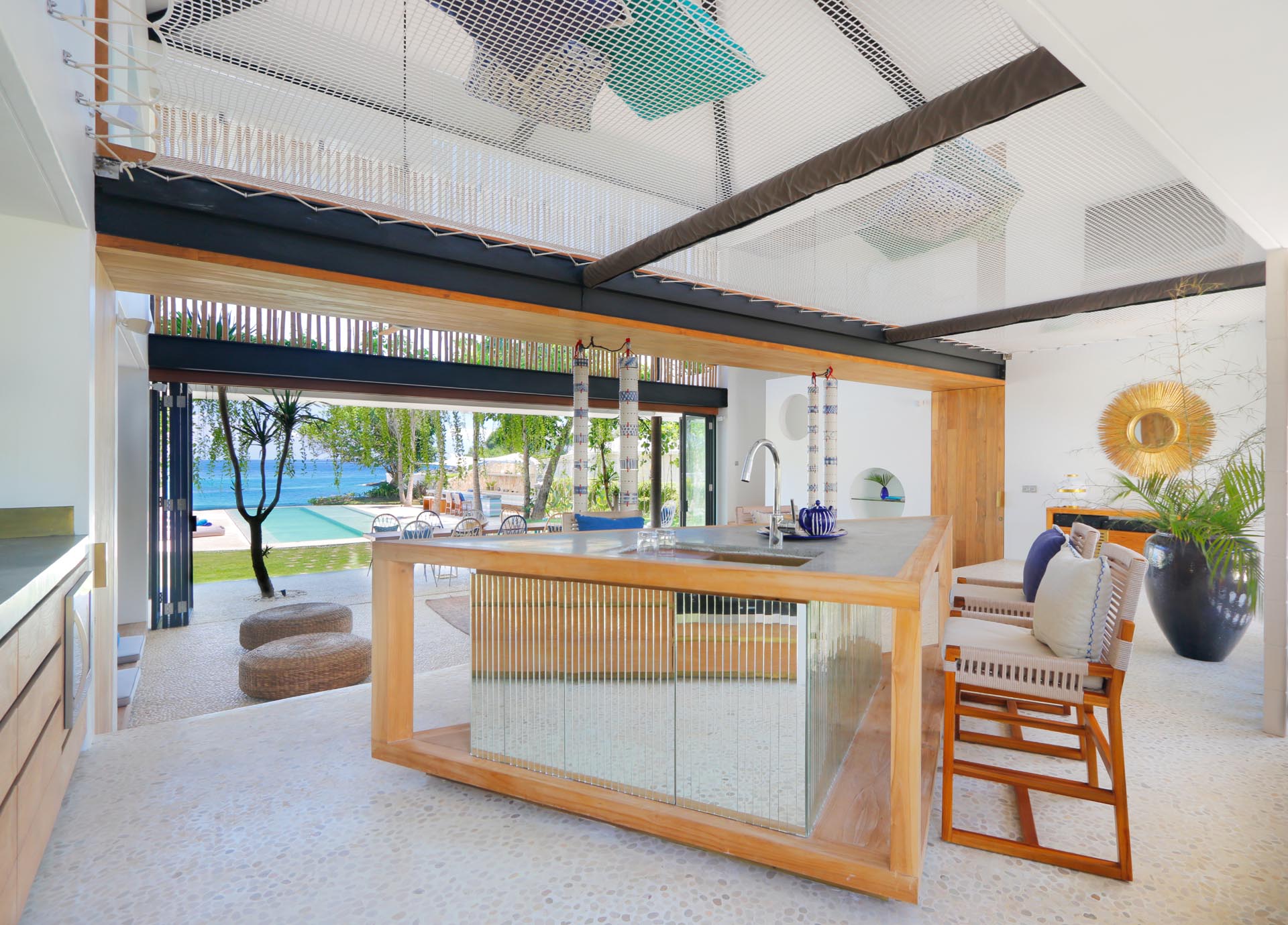 A modern beach house interior with a kitchen that includes a triangular island.