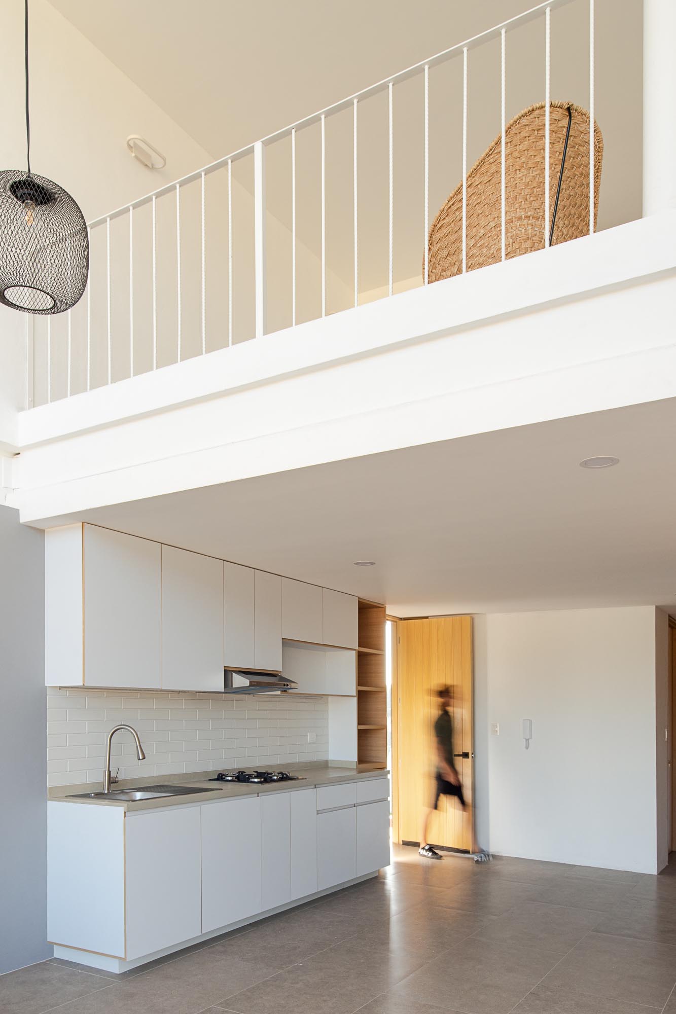 A modern loft apartment with minimalist kitchen.