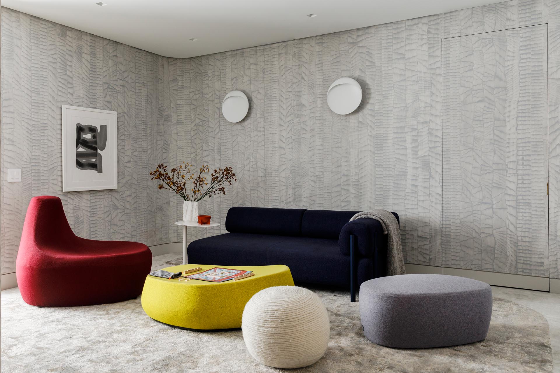 In this modern playroom, there's a hand-printed wallcovering and graphic carpet MKCA created with Stark Carpet. Complementing the walls are a range of vibrant and modern furnishings from Moroso and Hem.