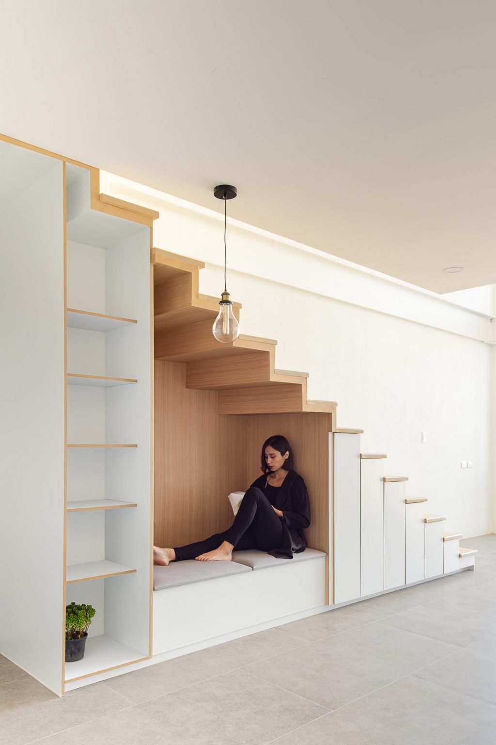 An UnderStair Seating Nook Lined With Wood Creates A Cozy Place For