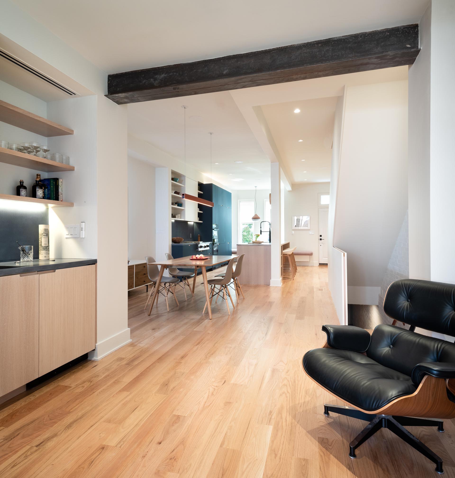 A modern and open plan kitchen and dining area with wood floors.